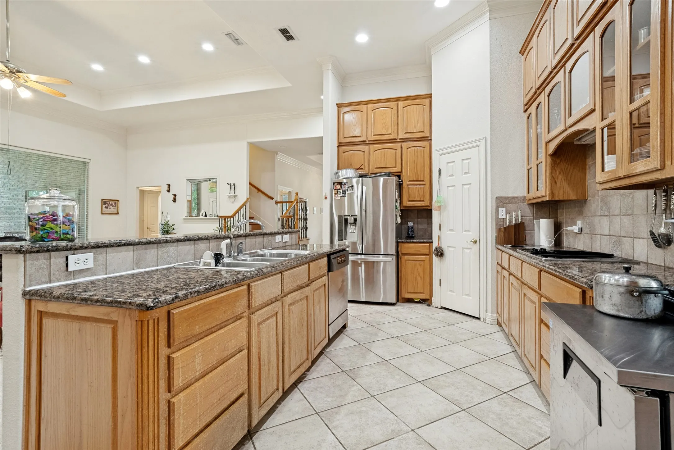 open kitchen with custom cabinetry,  walk-in pantry