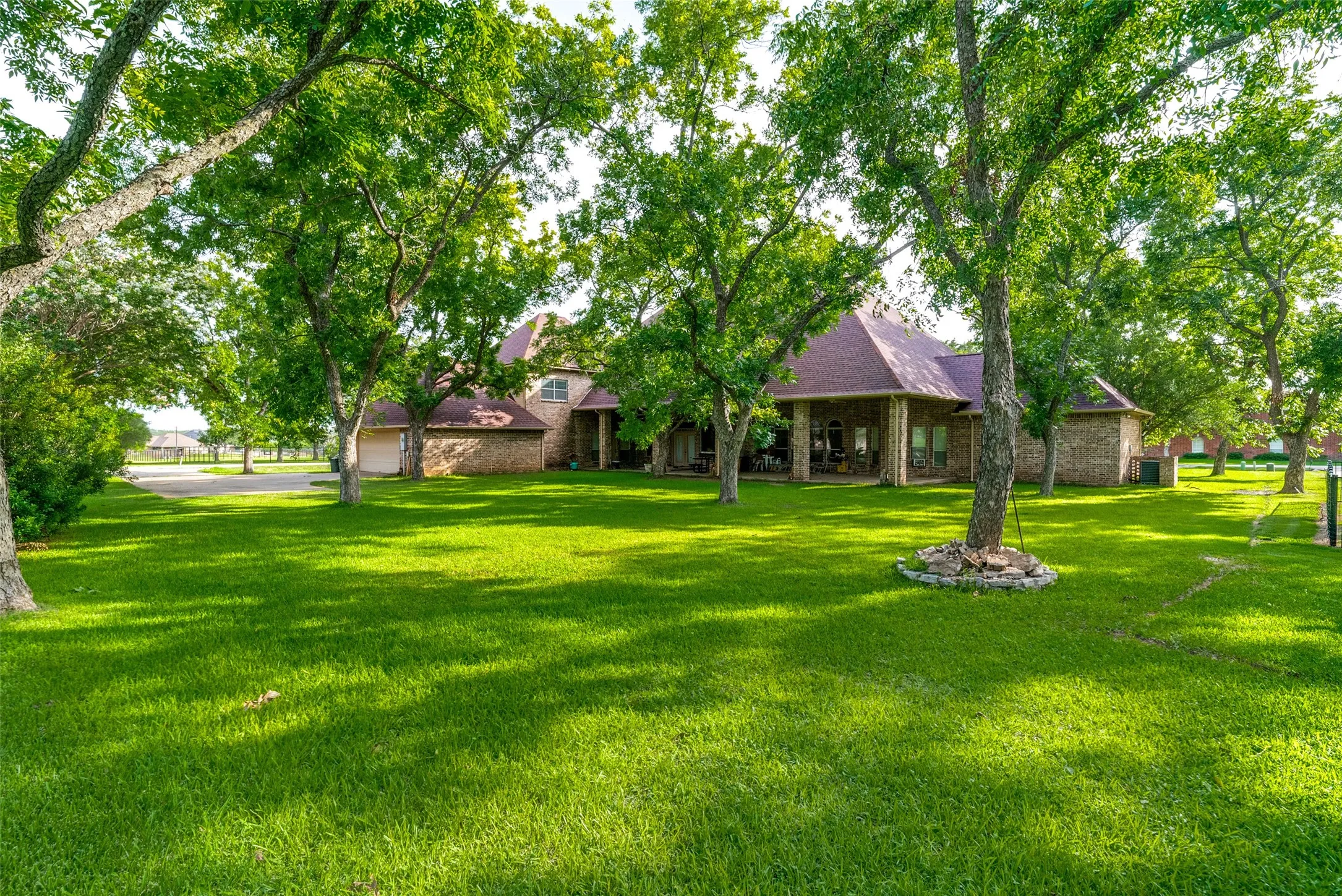 Spacious lawn with mature trees providing ample shade