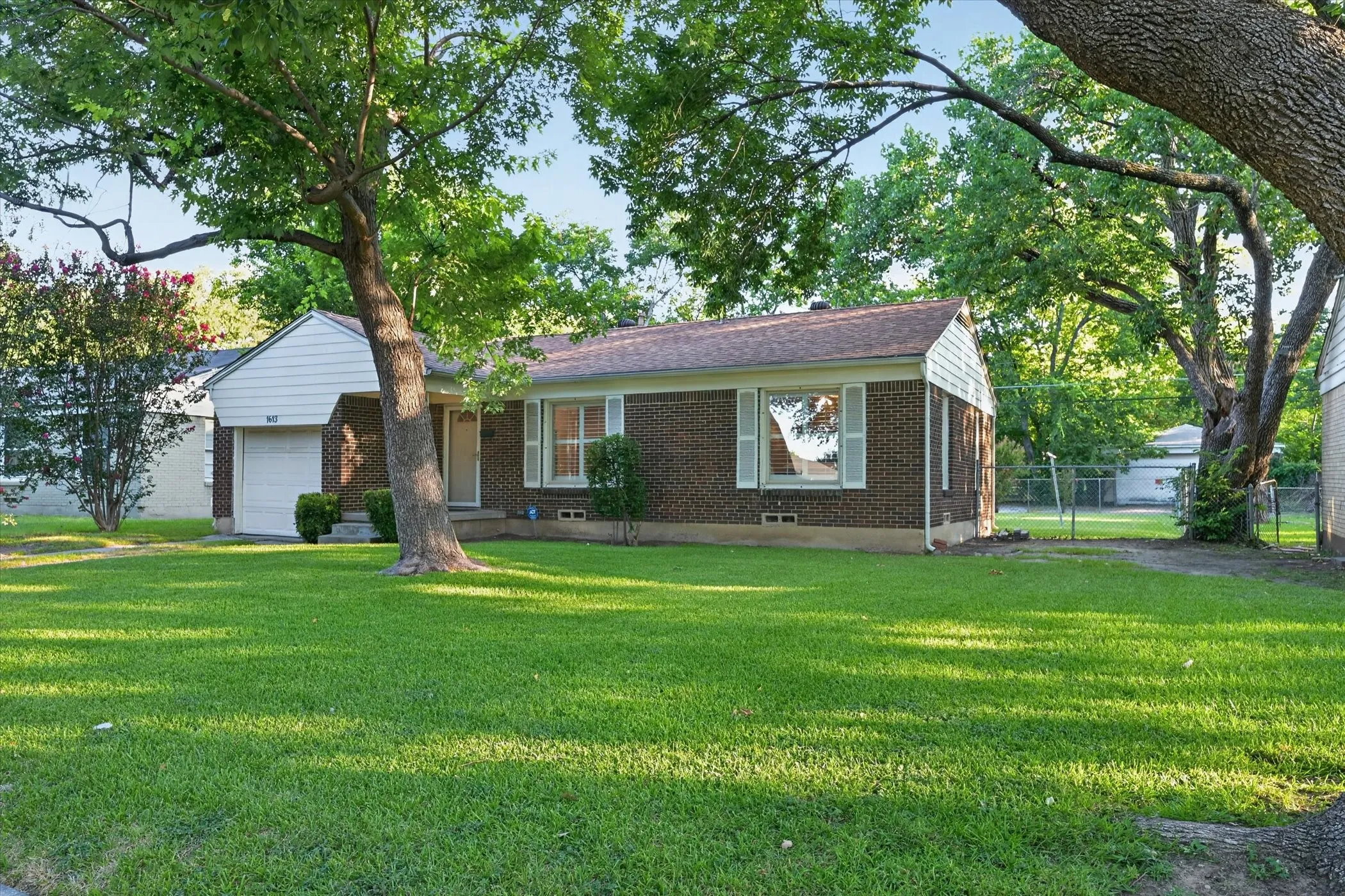 Brick-front home with white siding accents and a pitched roof