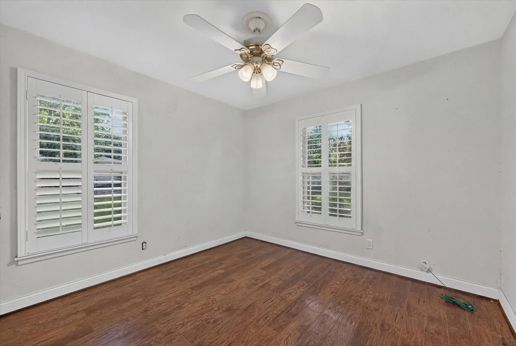 White walls with contrasting dark wood-finish flooring