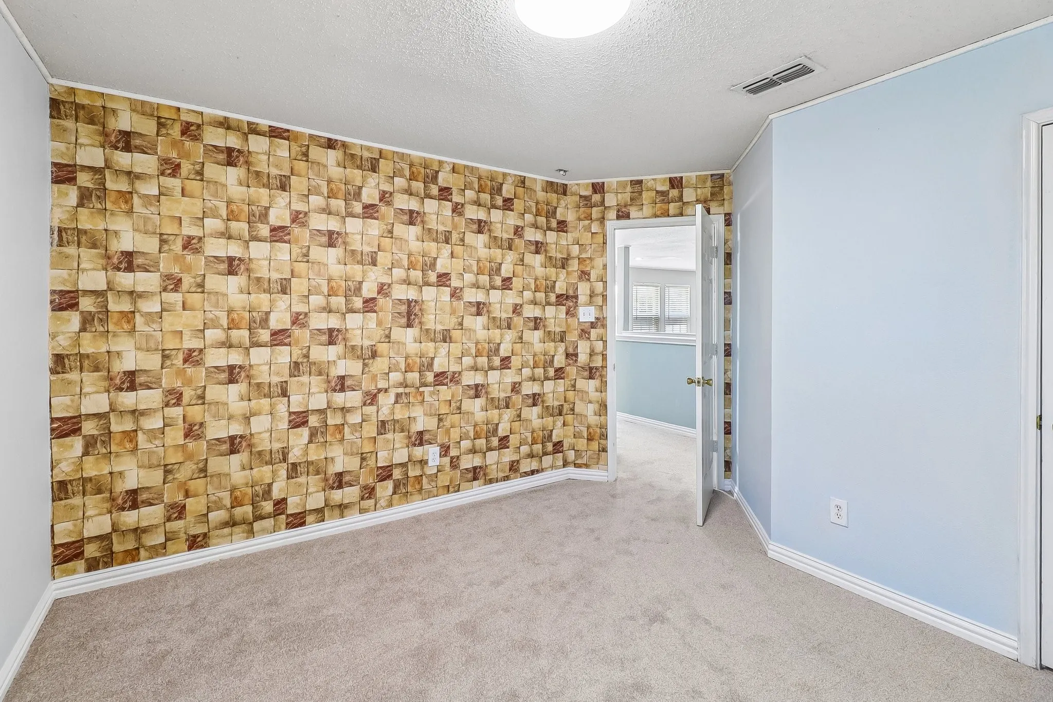 Spacious Bedroom with Wallpaper