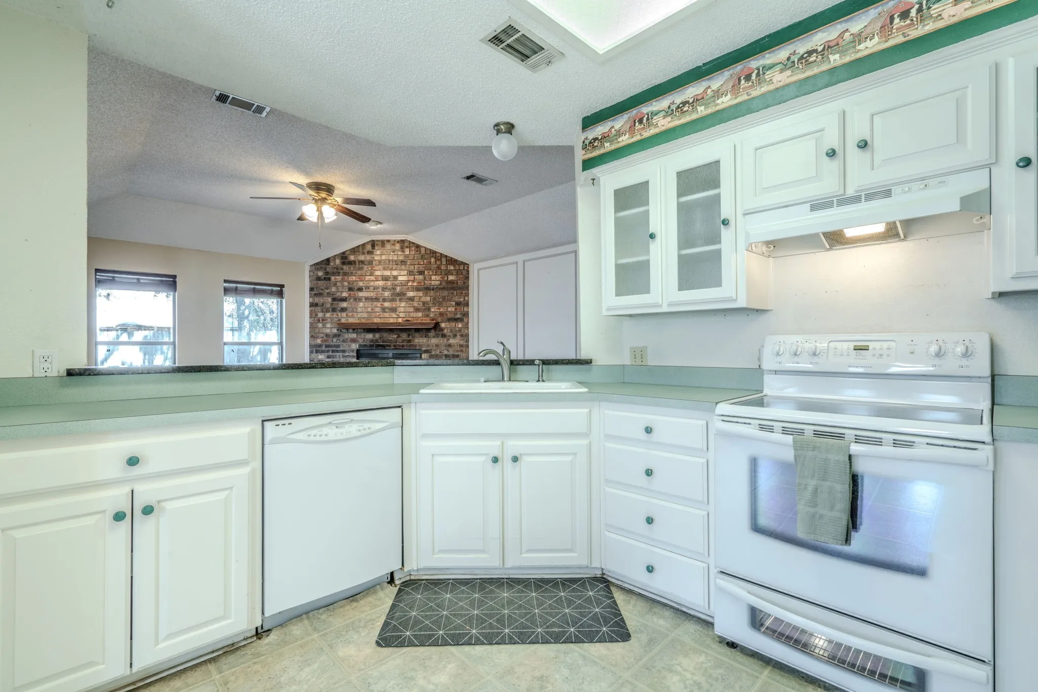 Spacious kitchen features a granite breakfast bar.