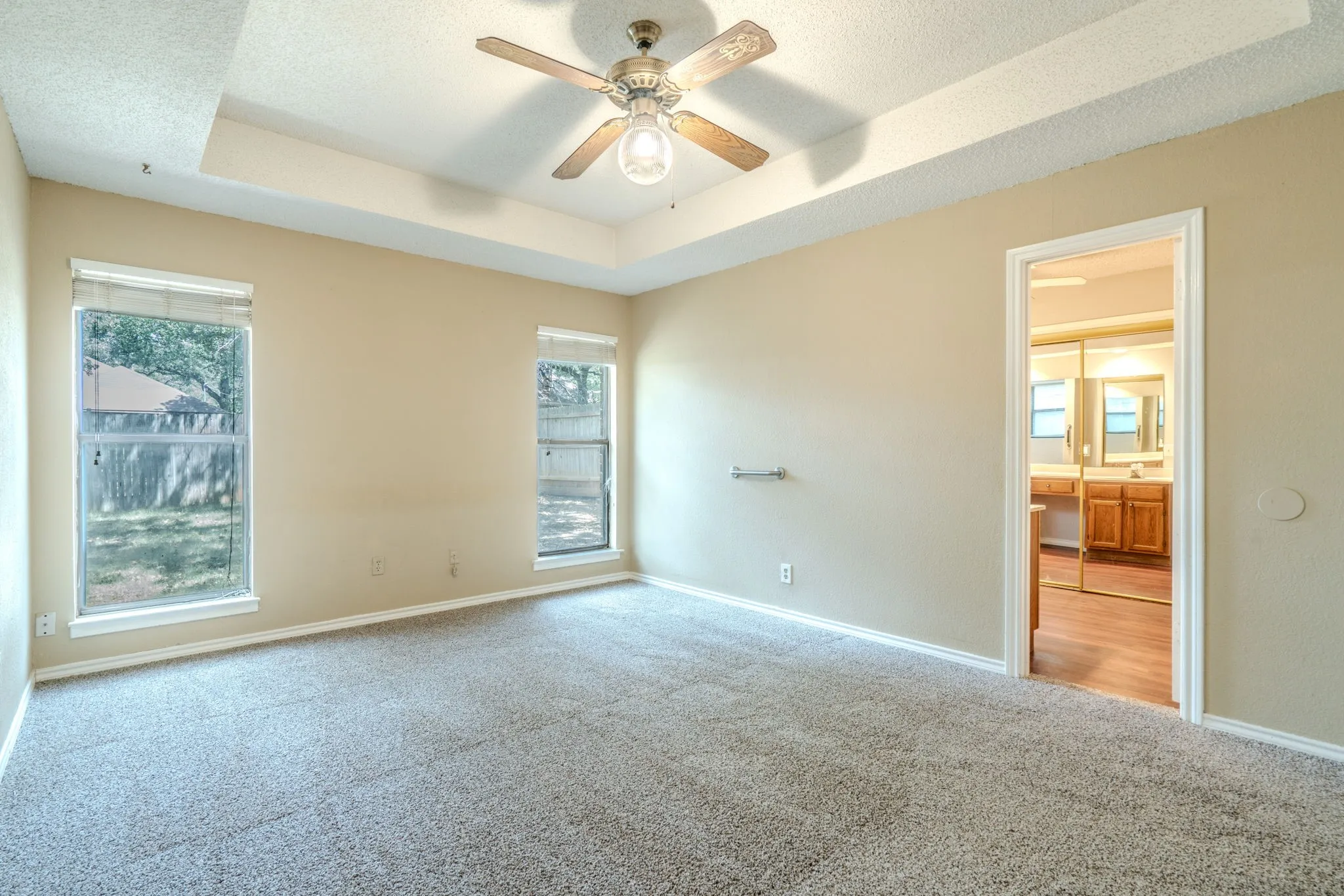 Primary bedroom with NEW CARPET and neutral colors.