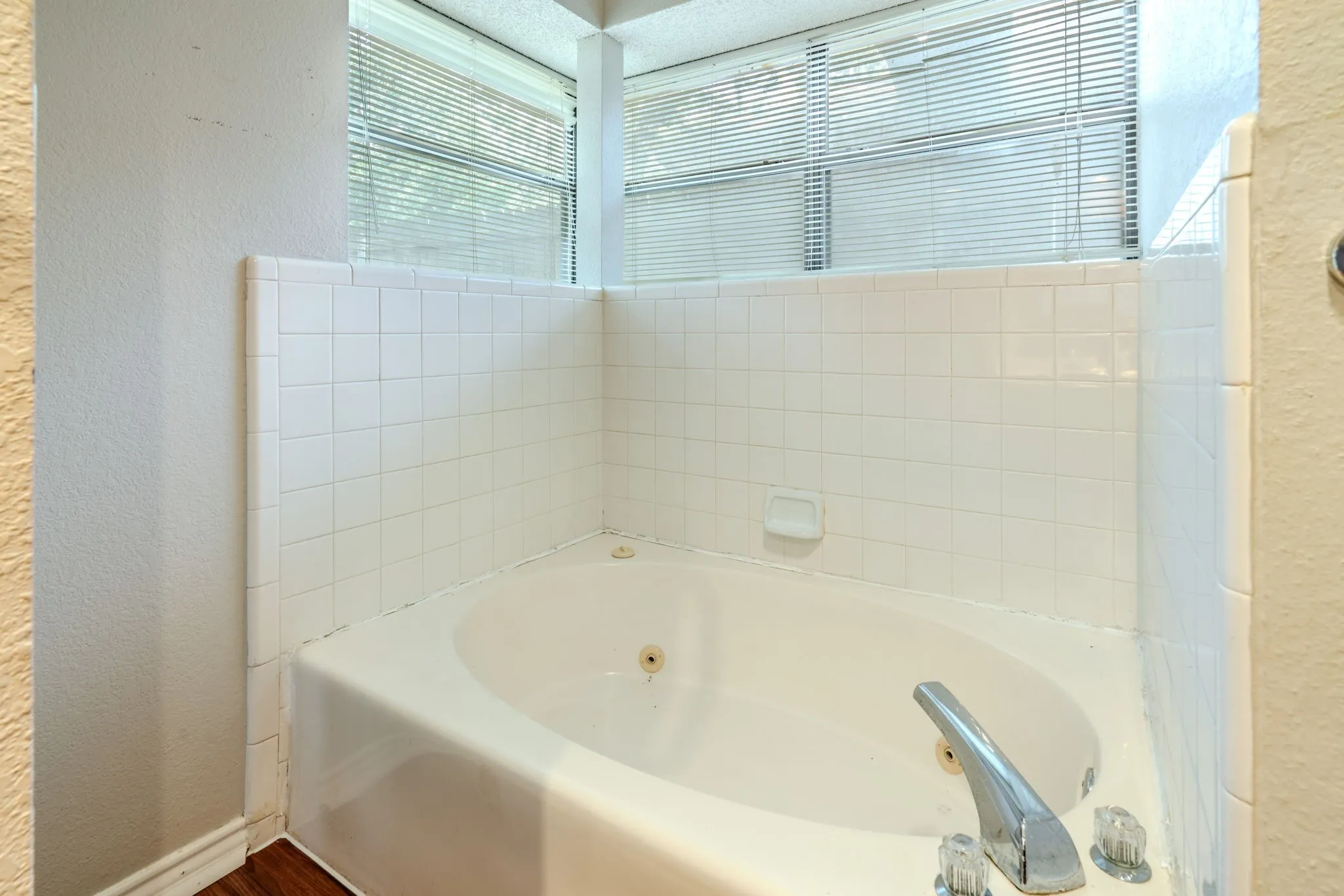 Primary bath features a jetted garden tub.
