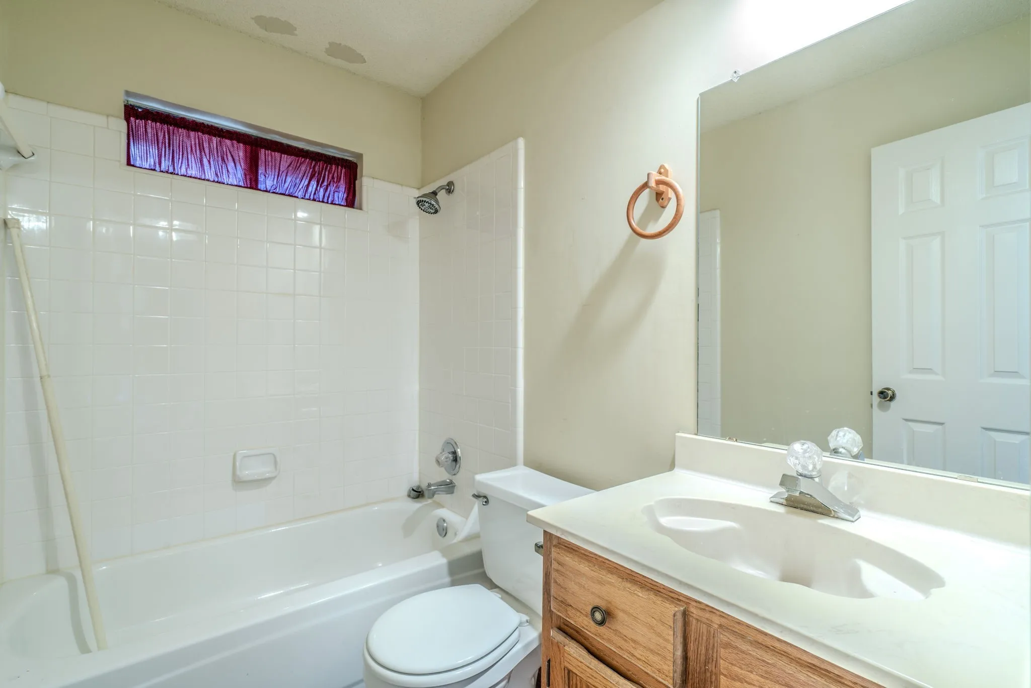 Hall bath features NEW VINYL PLANK FLOORING.