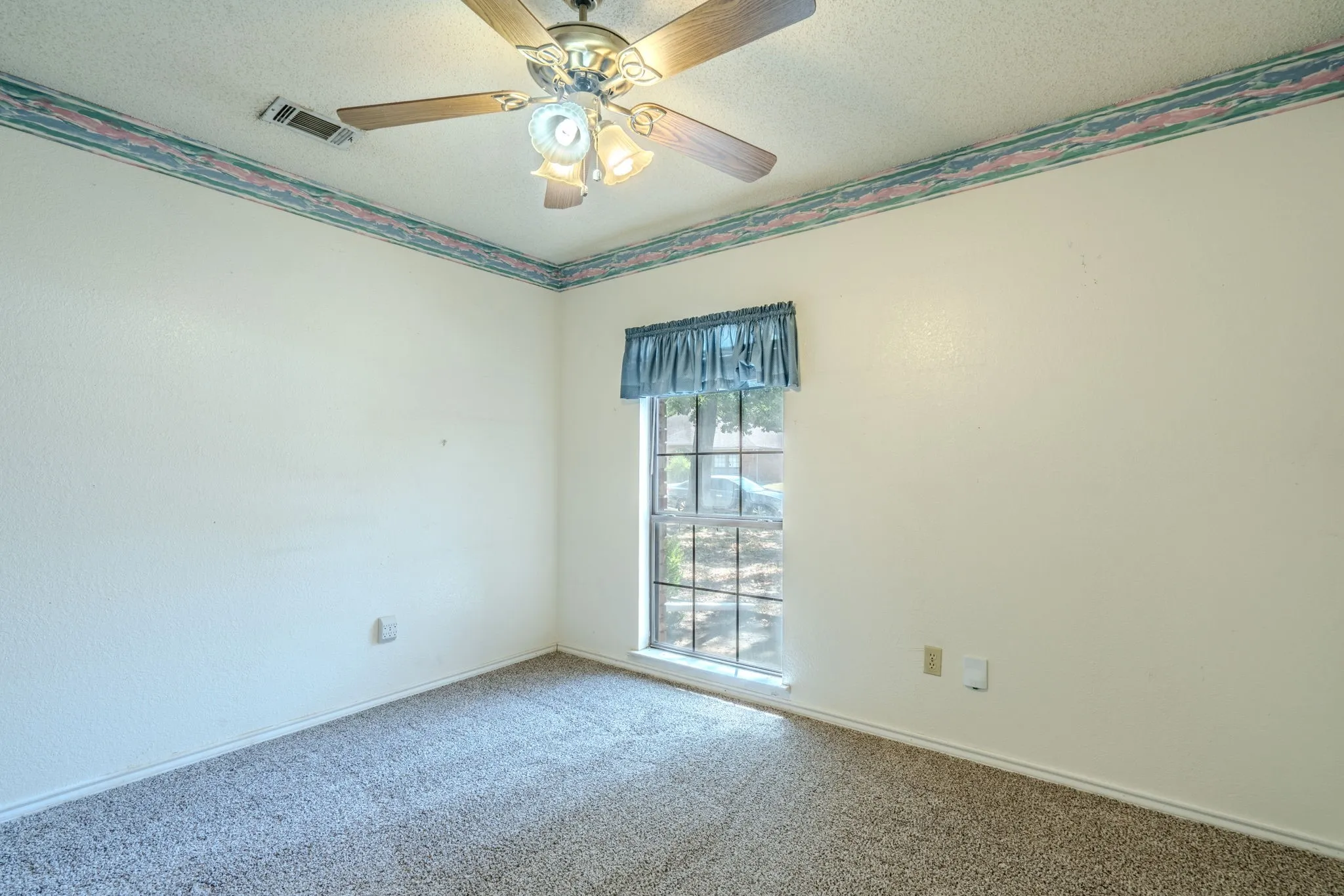 Another view of spacious secondary bedroom with neutral colors.