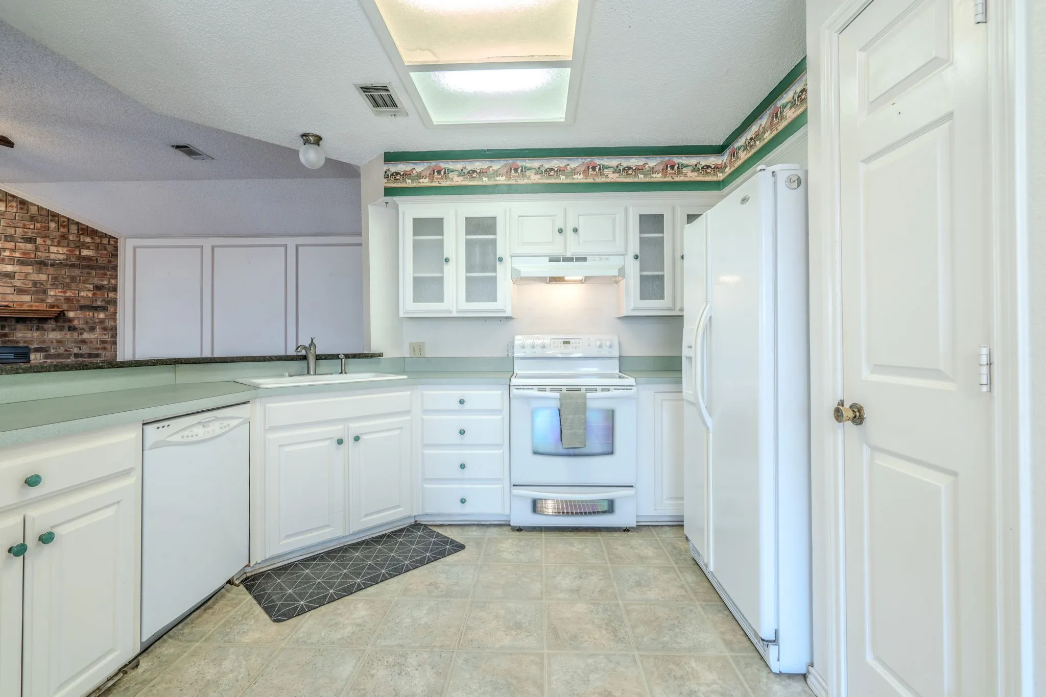Updated kitchen with glass-front cabinets and lots of storage.