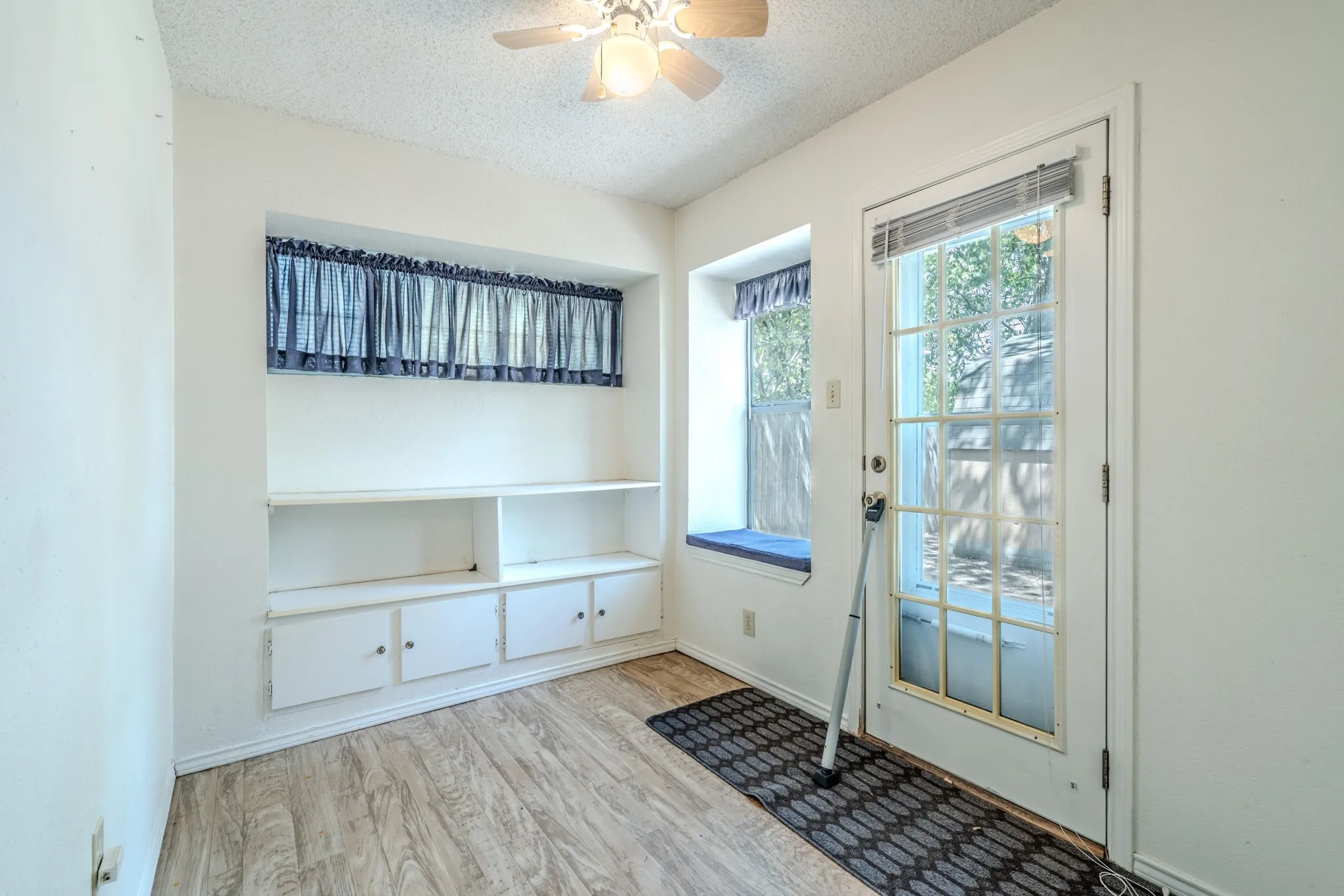 Bonus room with built-ins and exterior door is perfect for a home office.