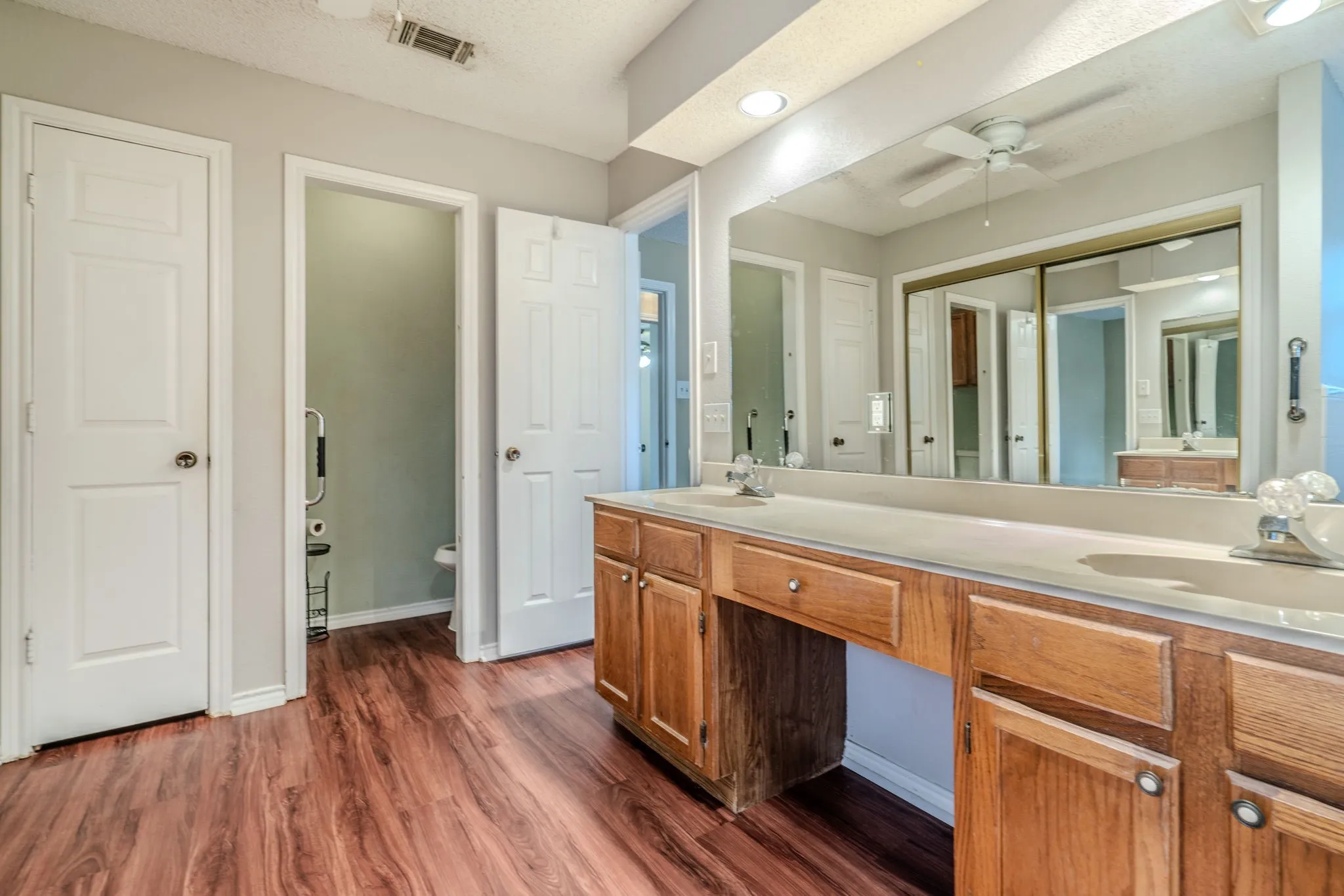 Primary bath features dual sinks and NEW VINYL PLANK FLOORING.