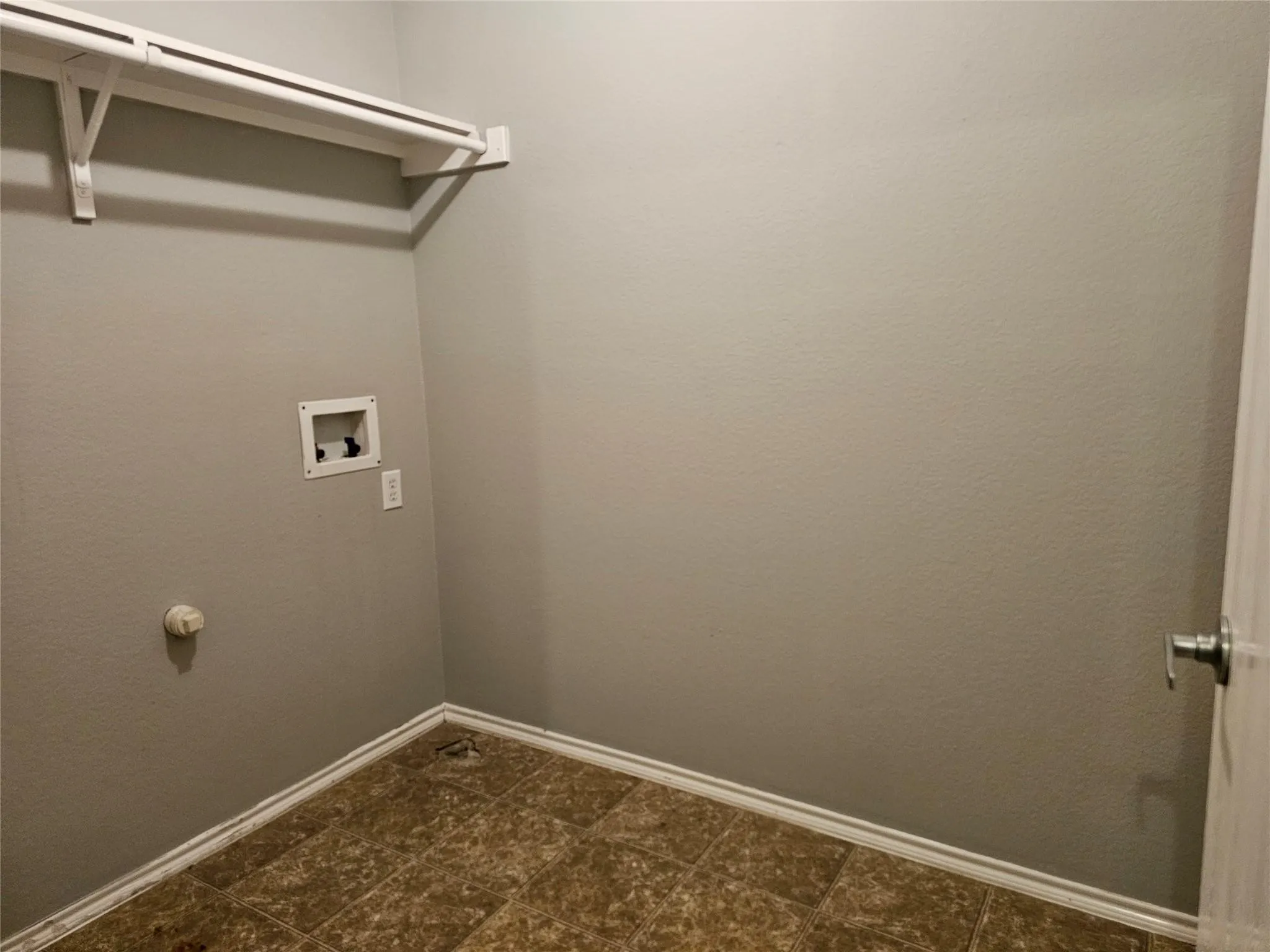 Laundry room with baseboards and hookup for a washing machine