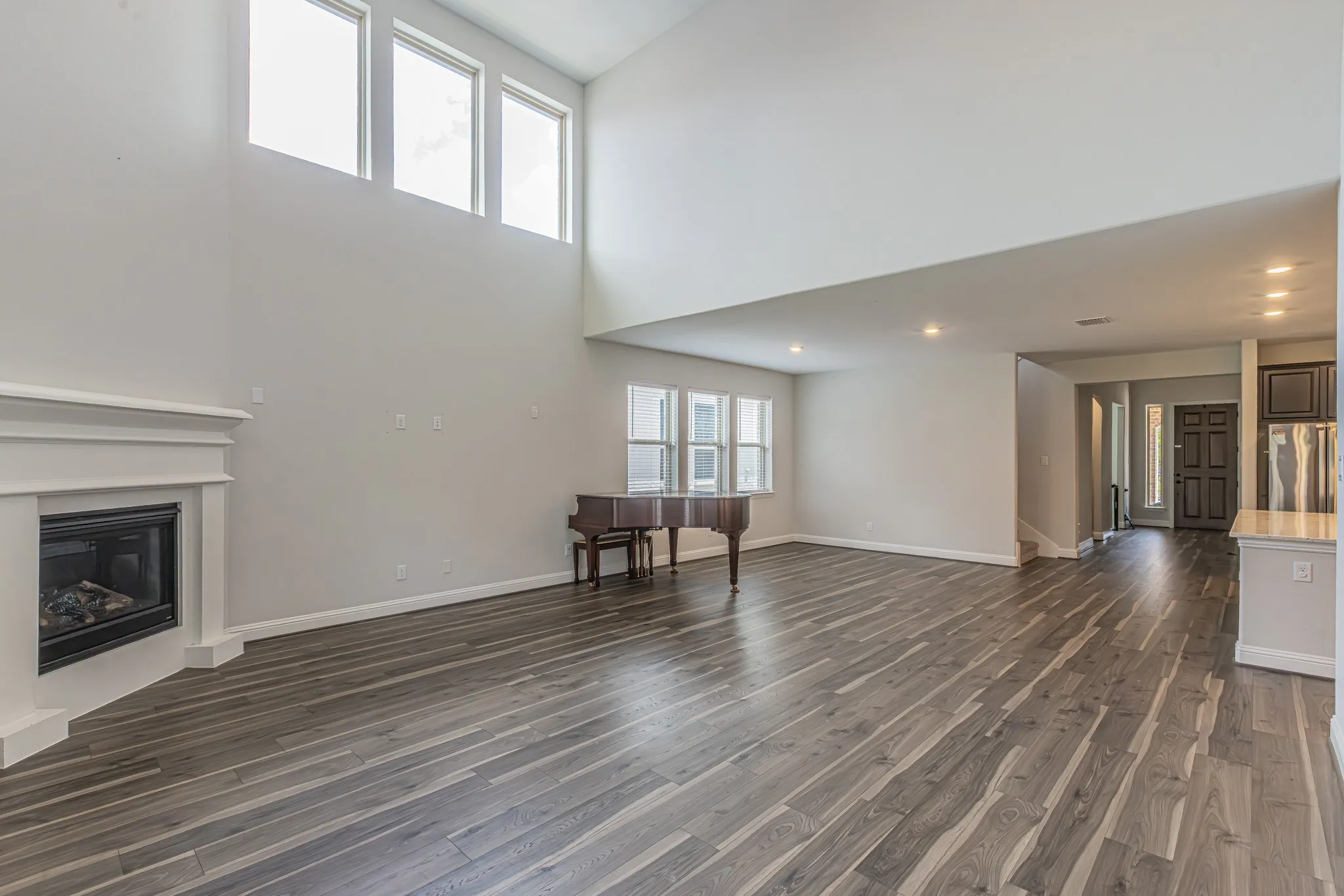 Living area featuring high ceilings and wood-finish flooring