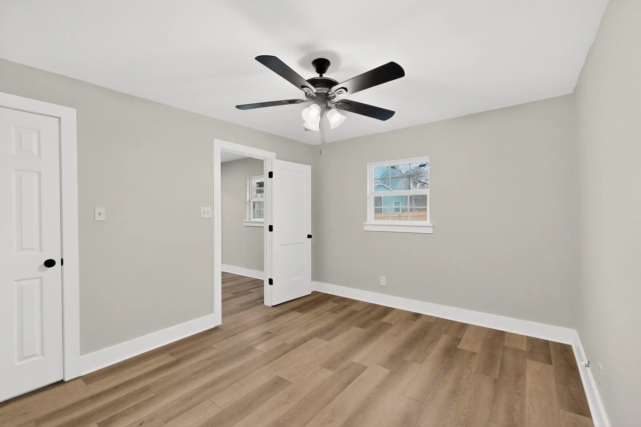 Light wood-finish flooring complements neutral wall tones