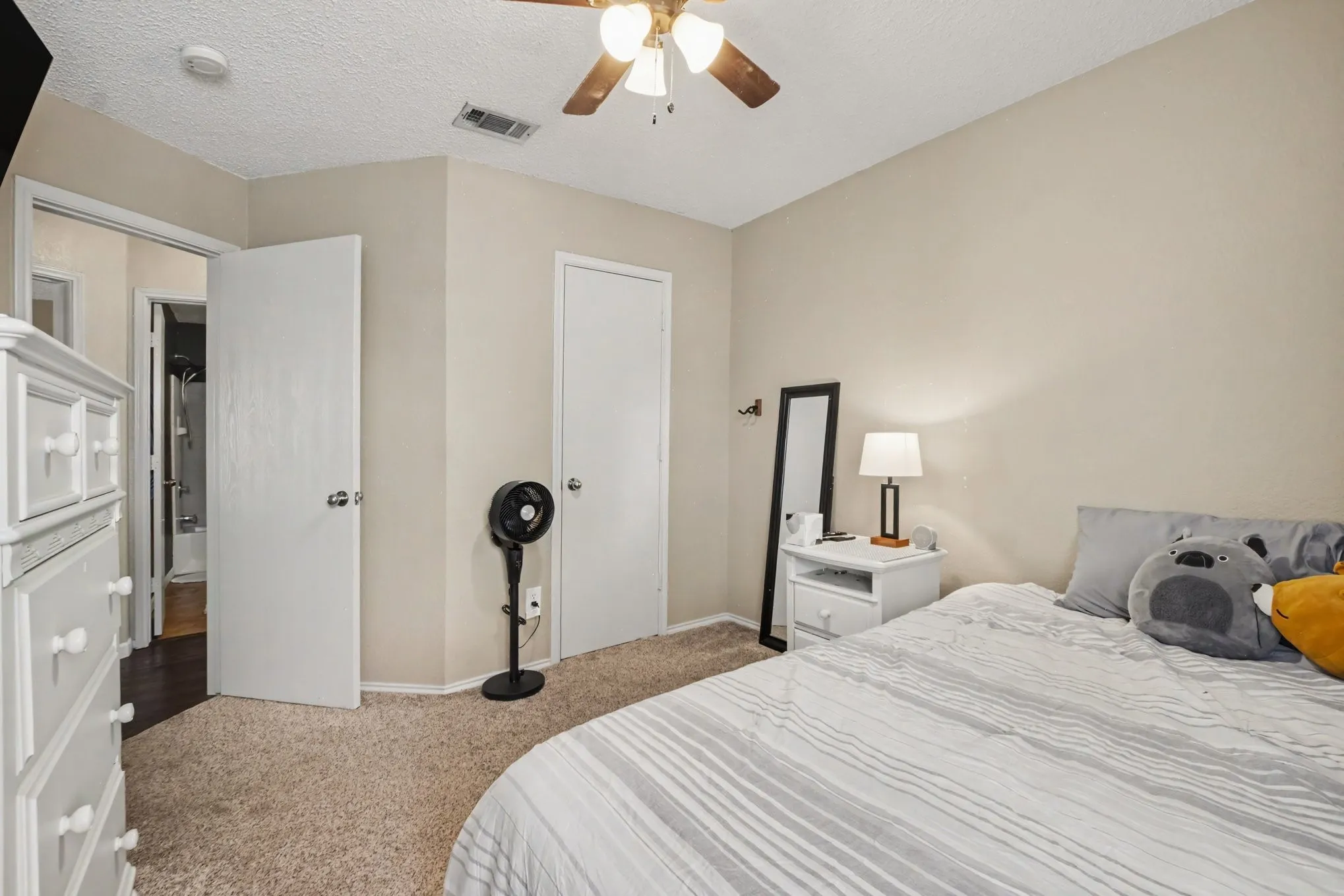 Carpeted bedroom with neutral wall tones