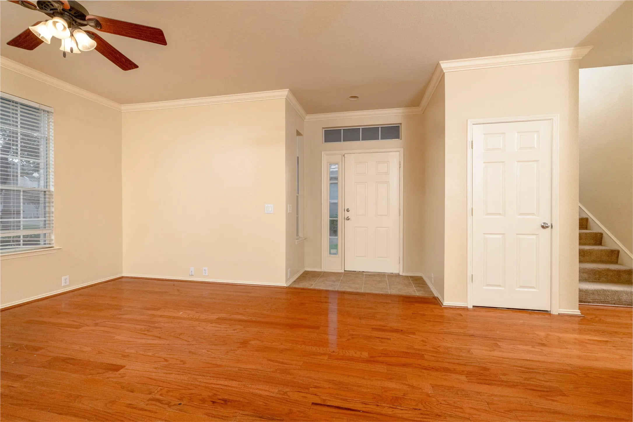 View to the Front Door Showing the SideLight & Transom Windows that Brings Natural Light & Under the Stairs Closet...