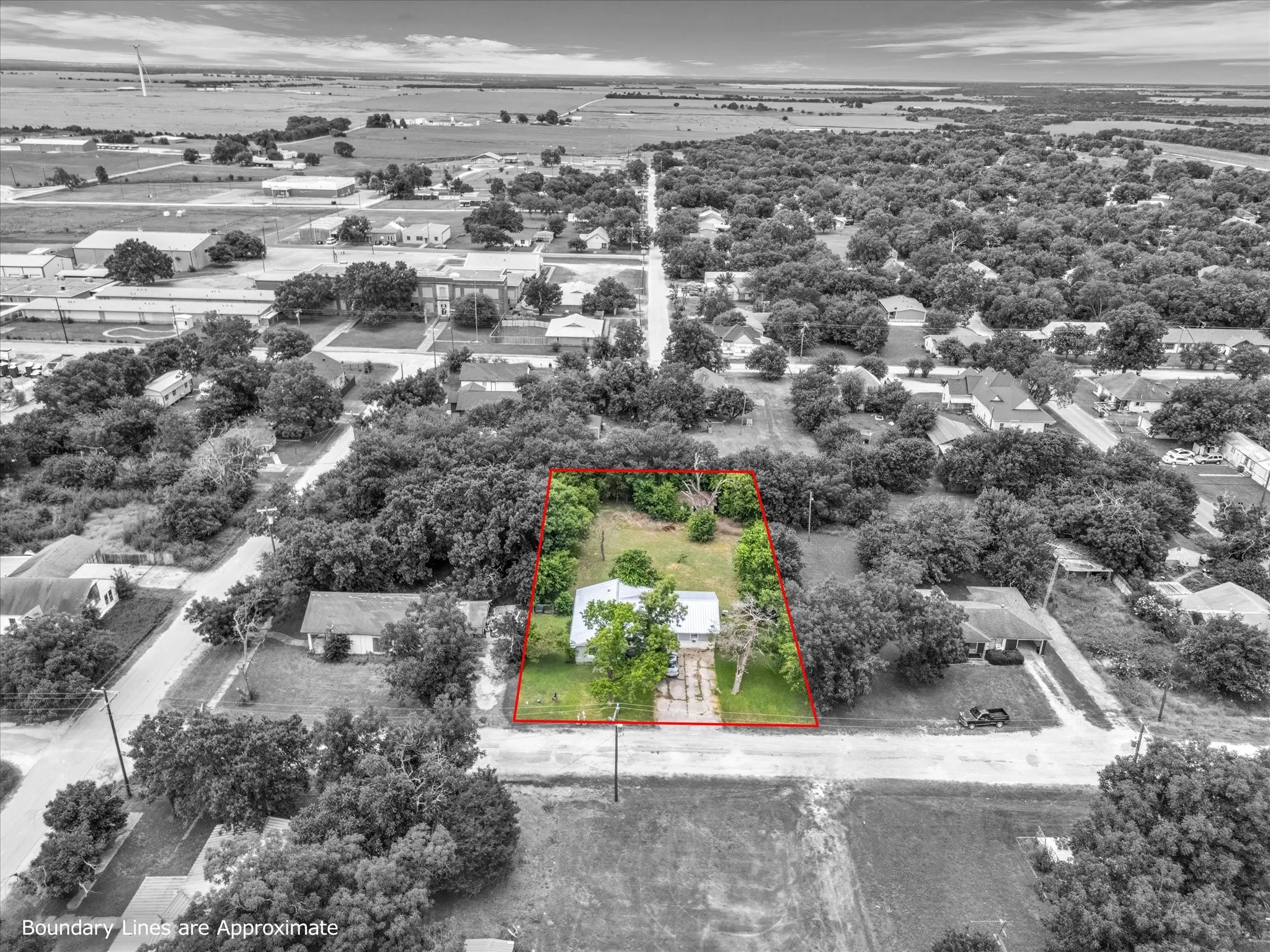 Aerial perspective highlighting a residential property with established trees