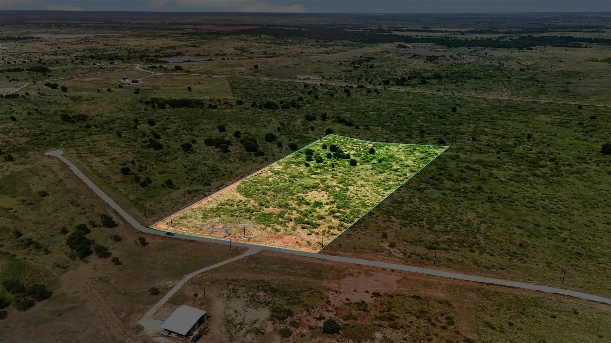 Expansive land parcel featuring natural vegetation and partial tree coverage