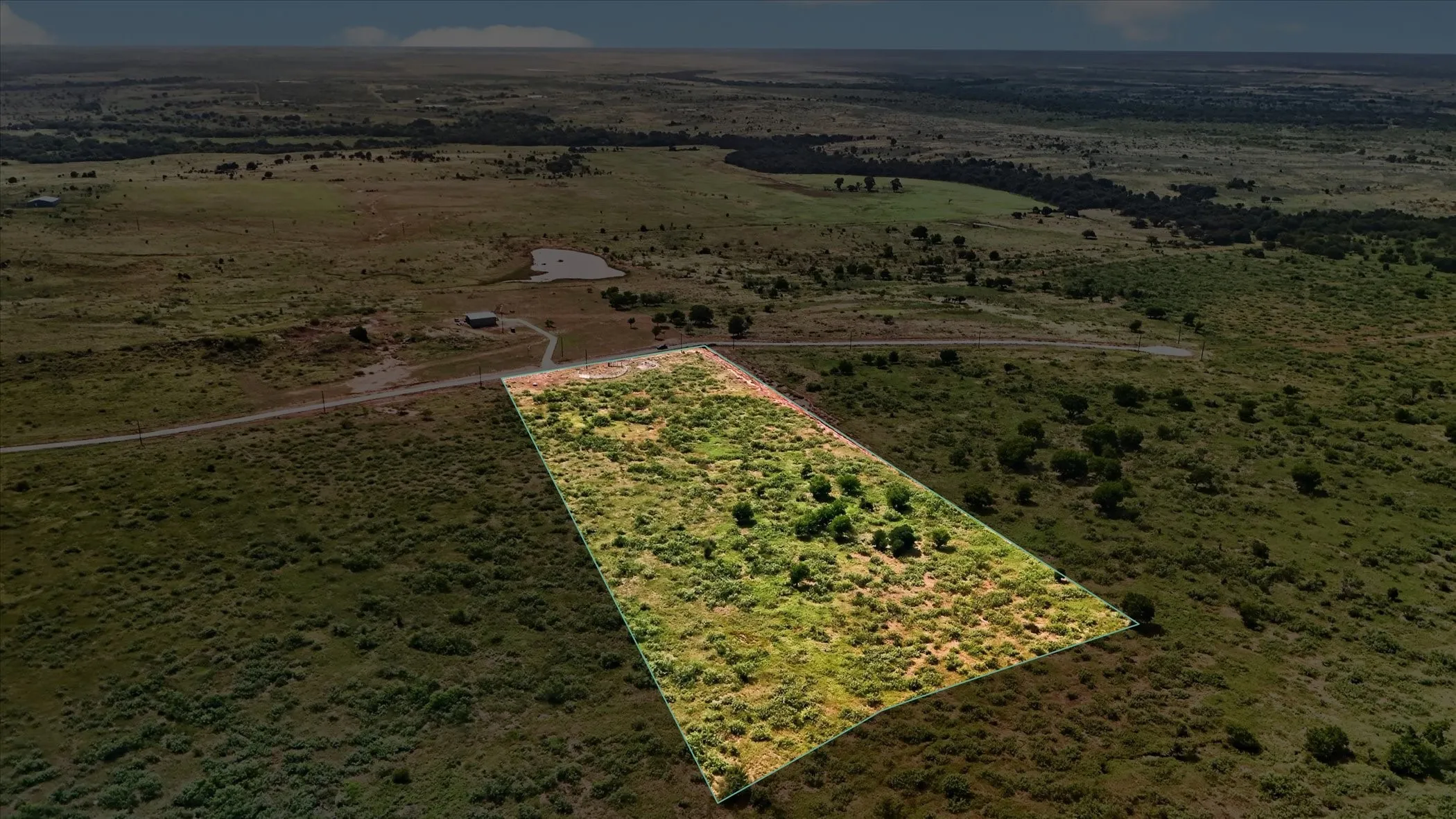 Expansive undeveloped land featuring diverse vegetation and scattered trees
