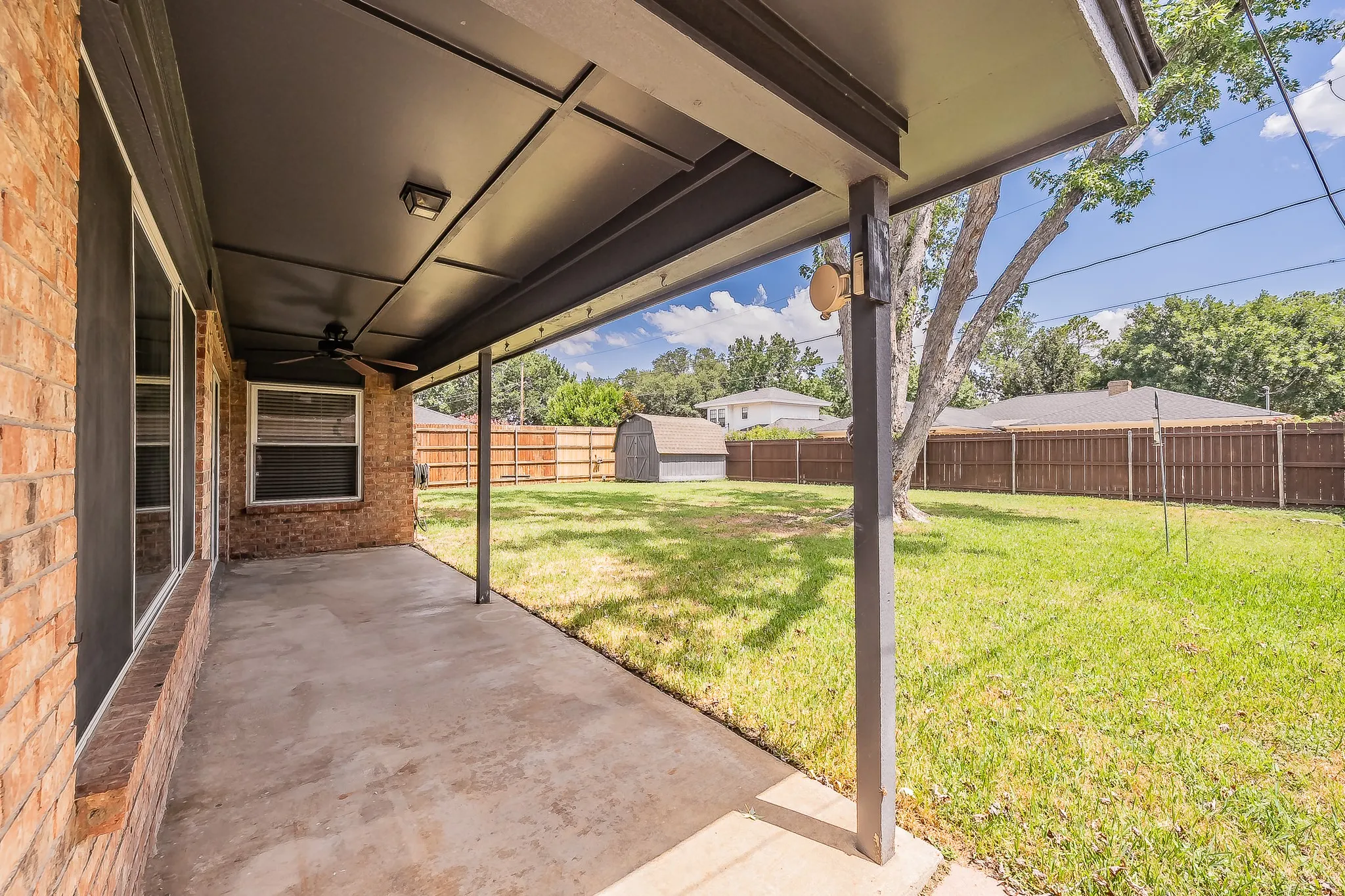 Wonderful space to enjoy being outside in the covered area, complete with a ceiling fan.