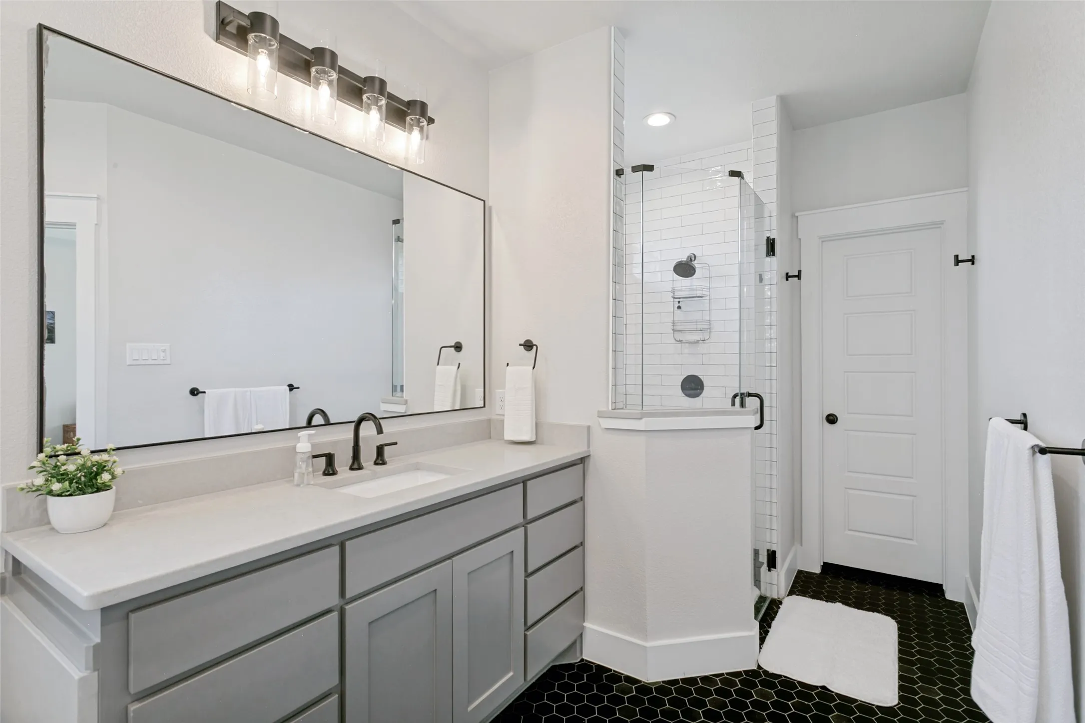 Primary bath with a stand alone tub, dual sinks, and a shower