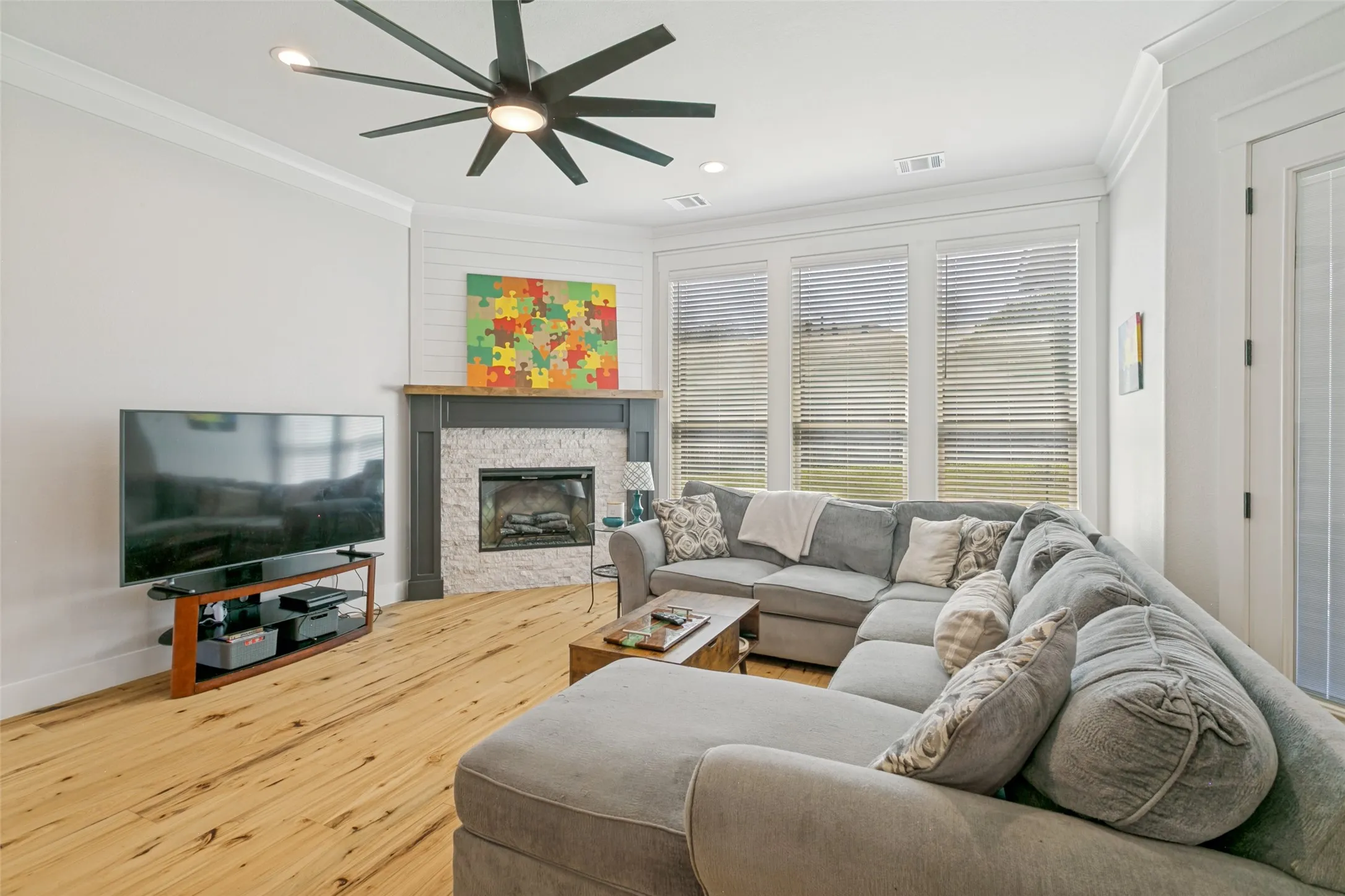 Living room features beautiful stone fireplace