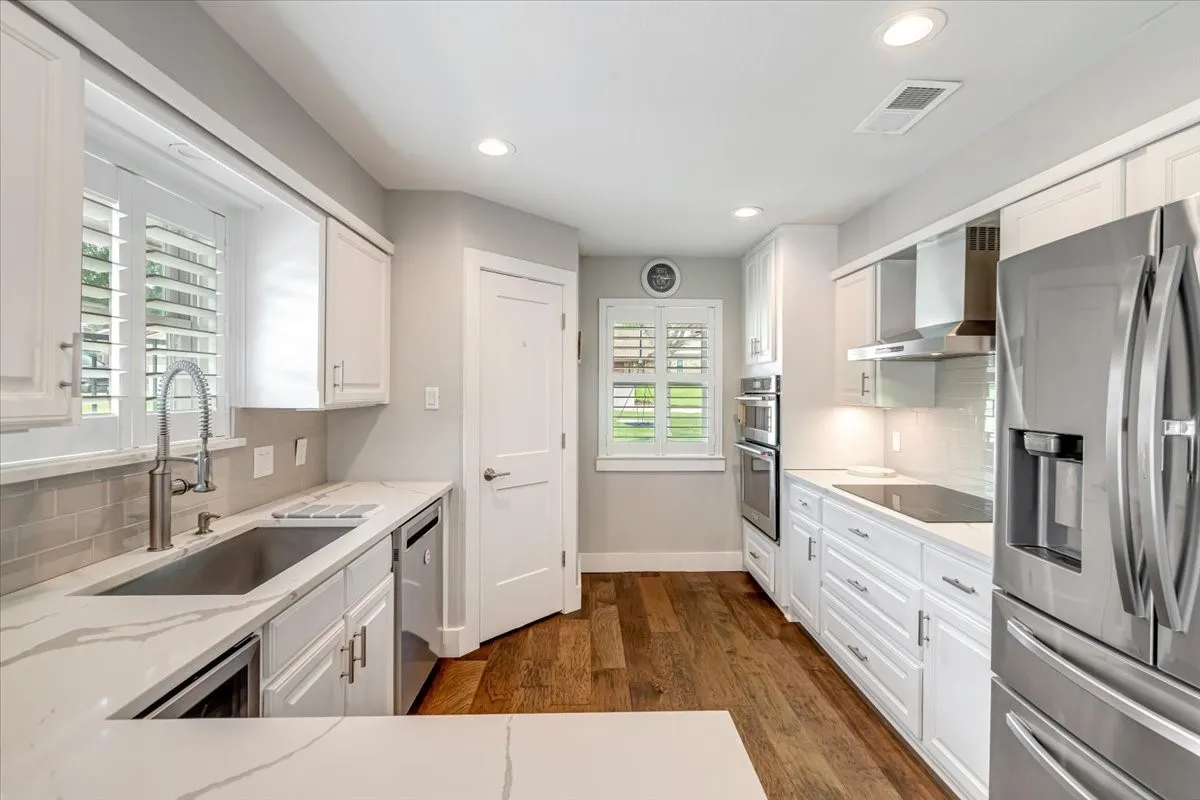 Large galley style kitchen featuring a built in wine cooler.