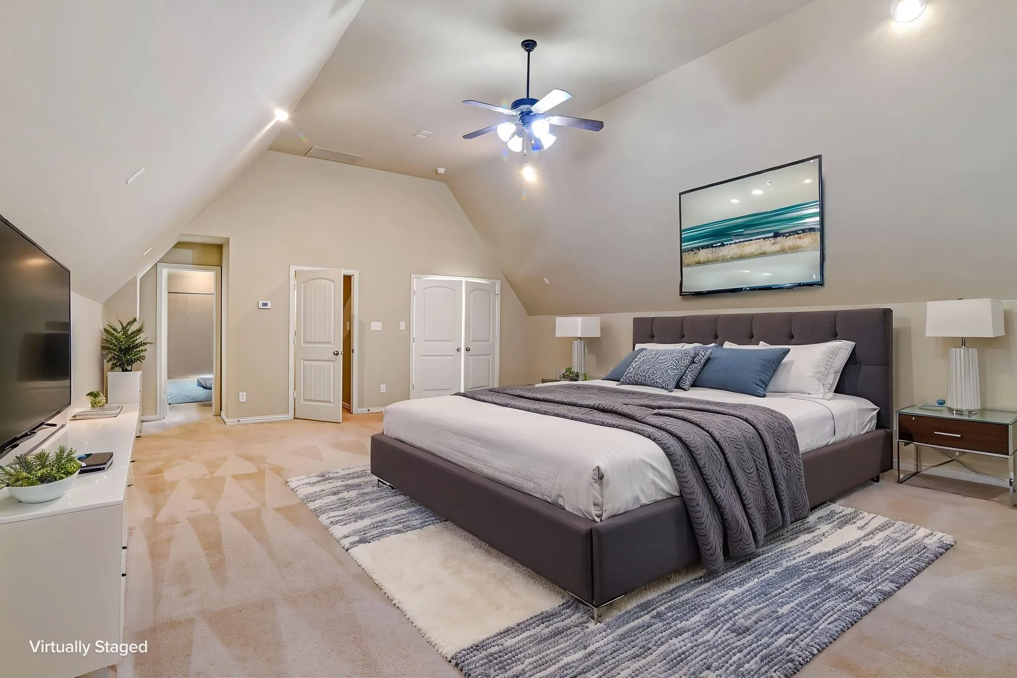 Vaulted ceilings with recessed lighting and a ceiling fan