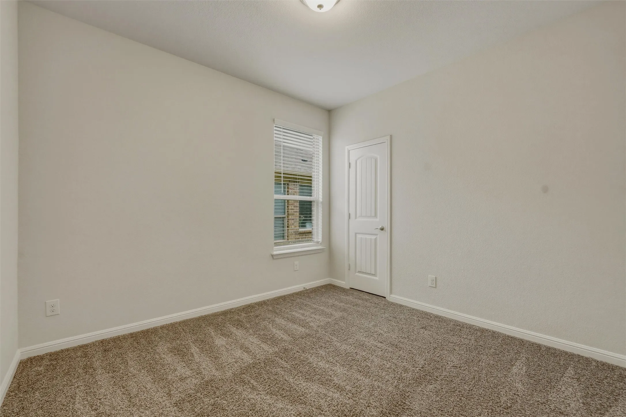 Neutral-toned interior room with textured carpeting
