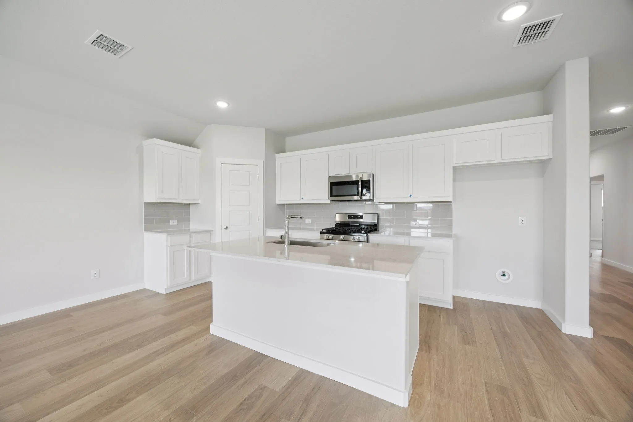 Kitchen in the Hadley home plan by Trophy Signature Homes – REPRESENTATIVE PHOTO