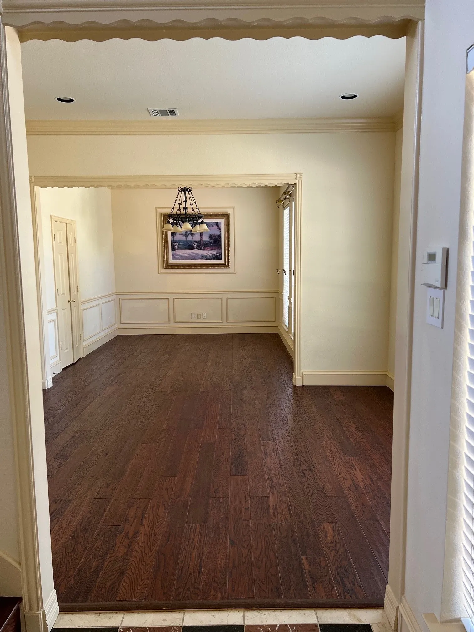 Unfurnished room with dark hardwood / wood-style flooring and ornamental molding