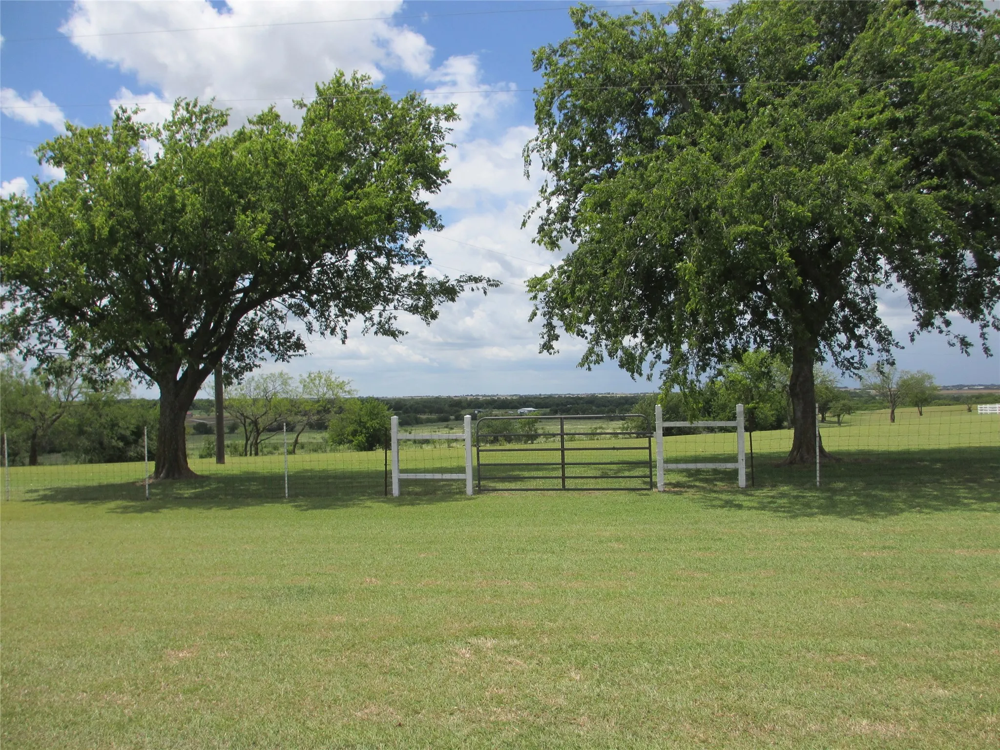 Fence and gate dividing the home site from the 3.57 back acreage- Great place for your horses and other animals.
