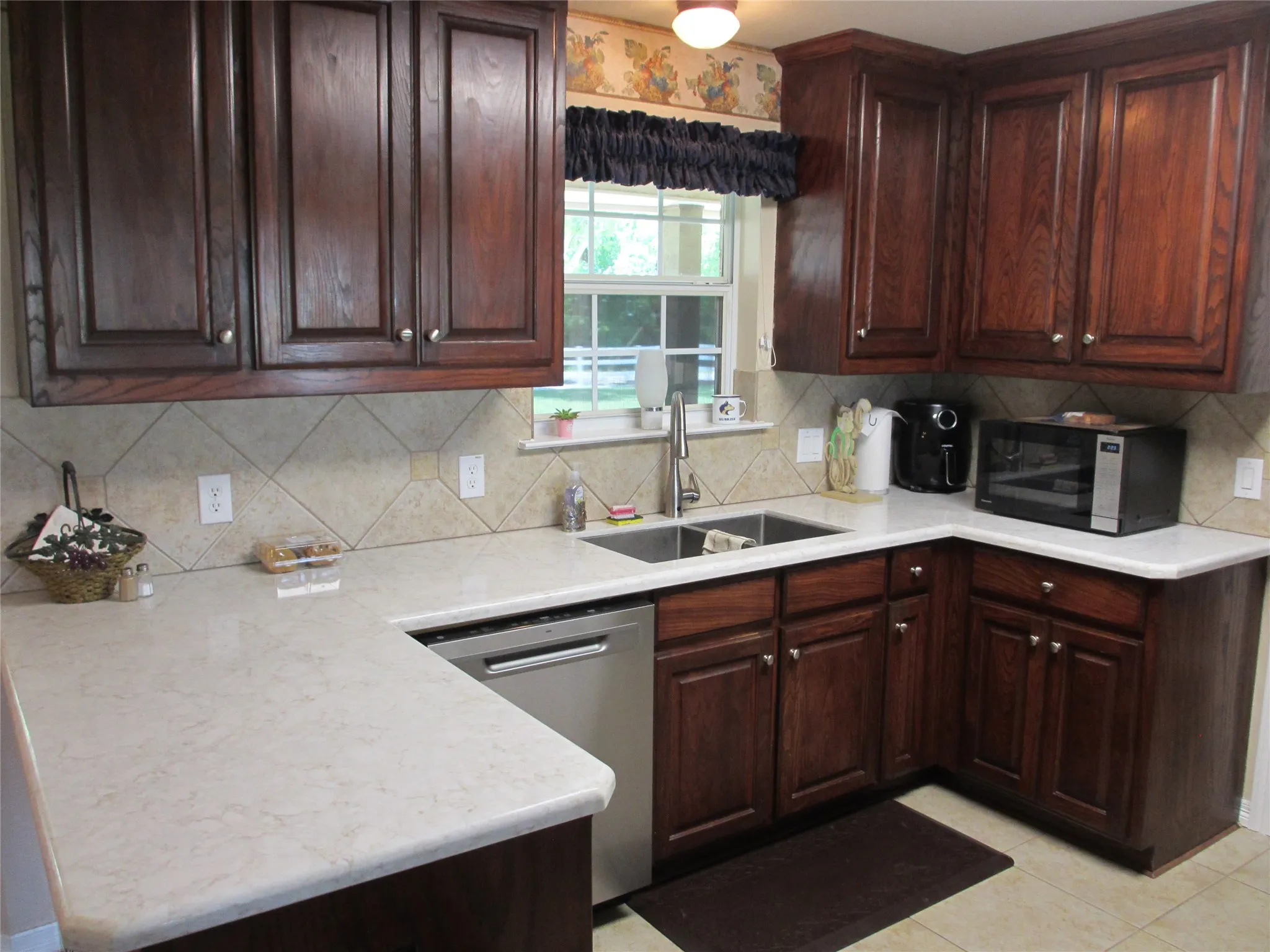 Kitchen with new countertops, dishwasher and stainless steel appliances