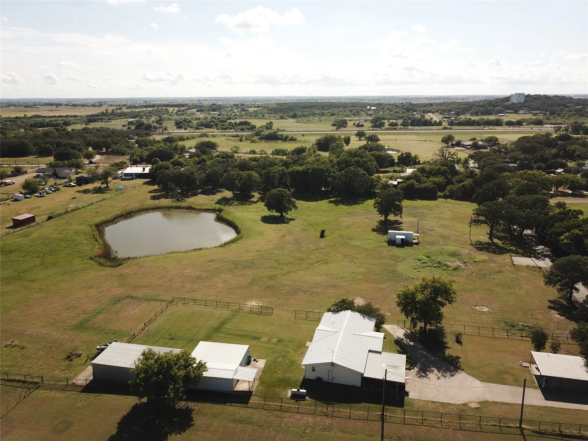 Expansive property featuring a private pond and multiple structures