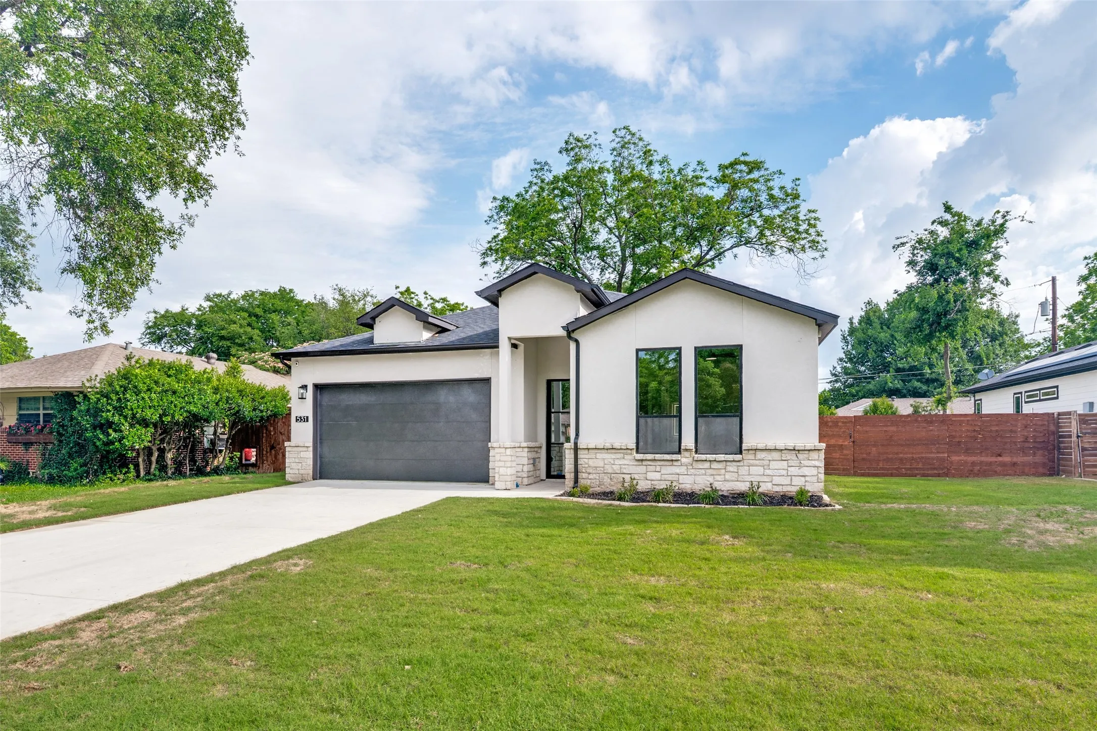 Contemporary stucco exterior with stone accents