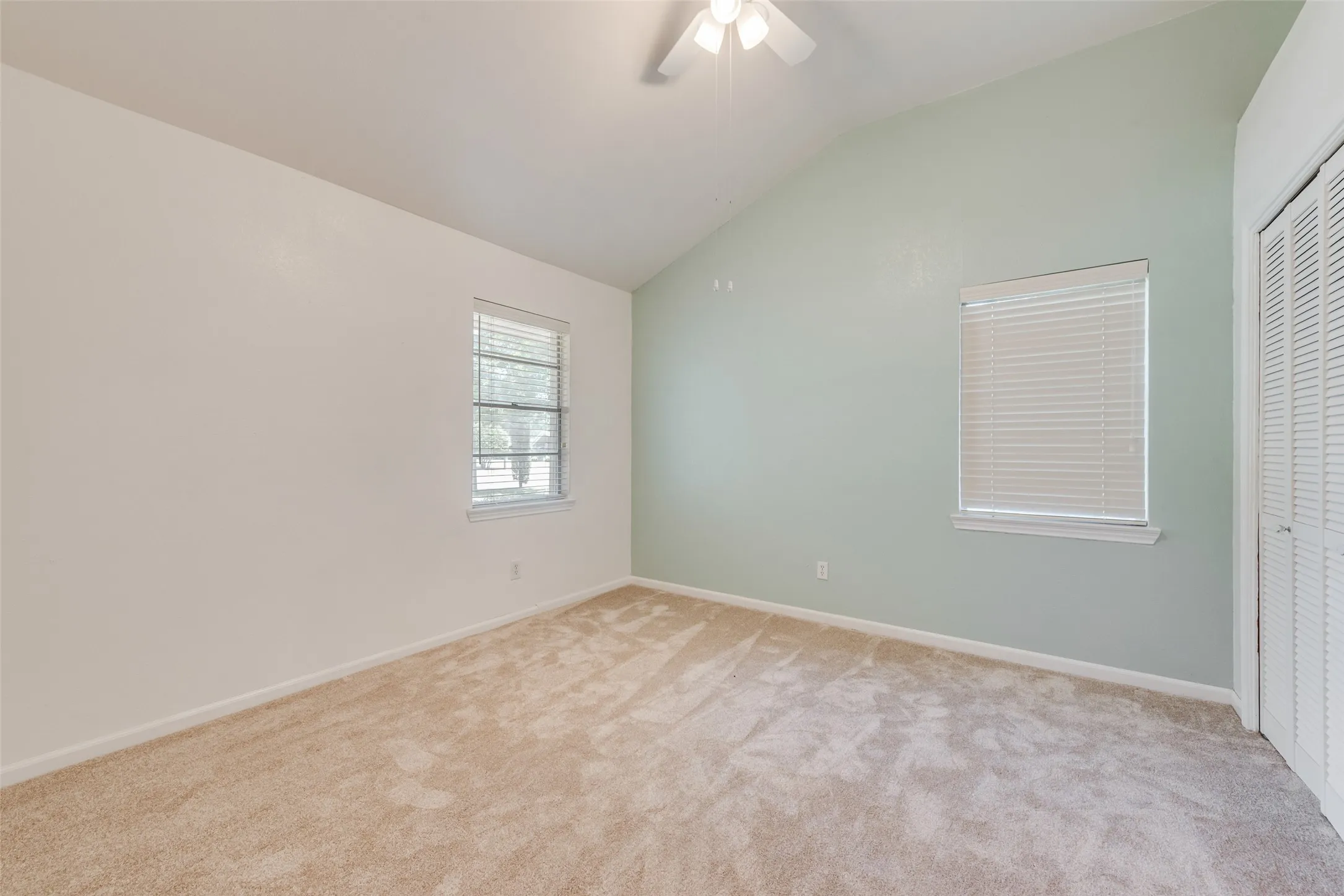 Third bedroom featuring a vaulted ceiling