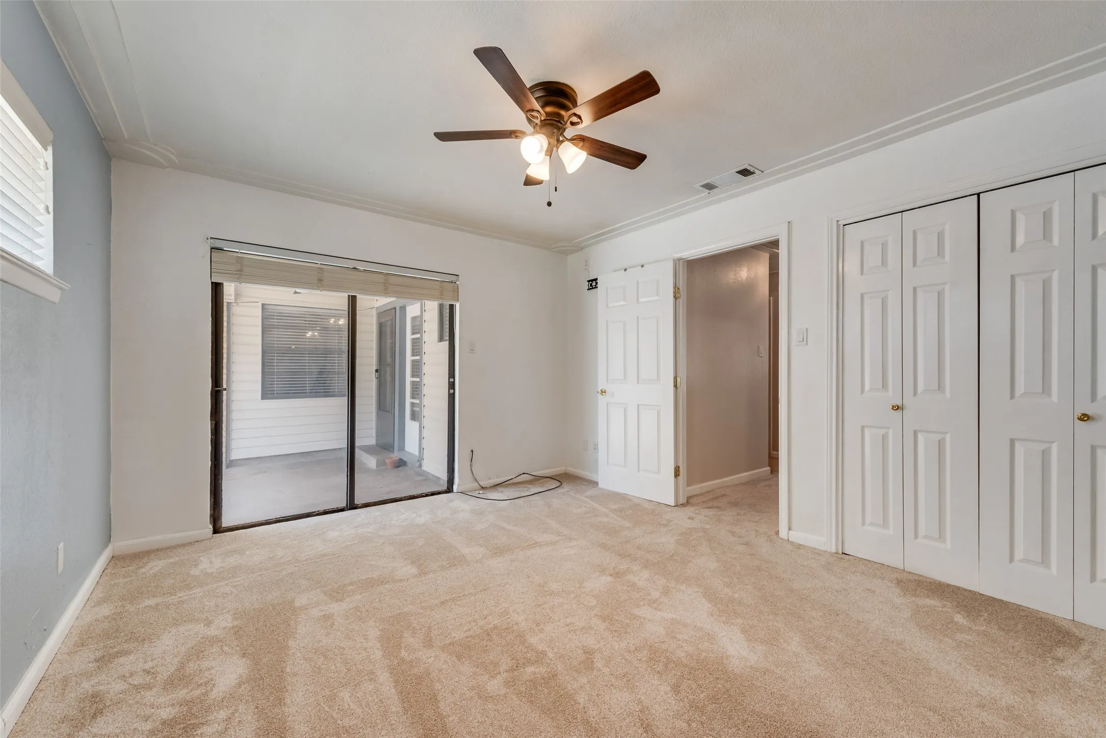 Primary bedroom with access to backyard covered patio