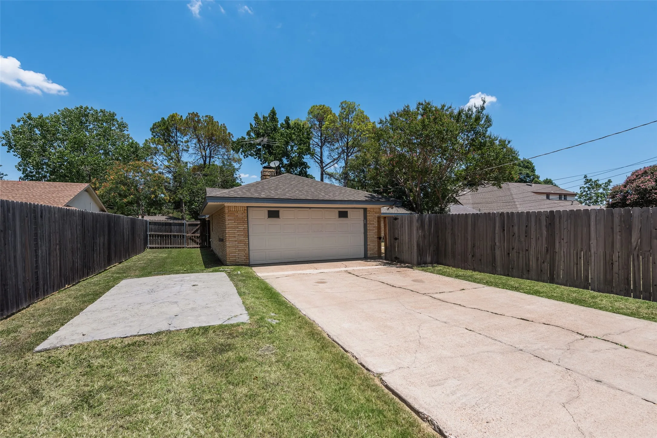 Alley access to large driveway, 2 car attached garage, and additional concrete pad for parking