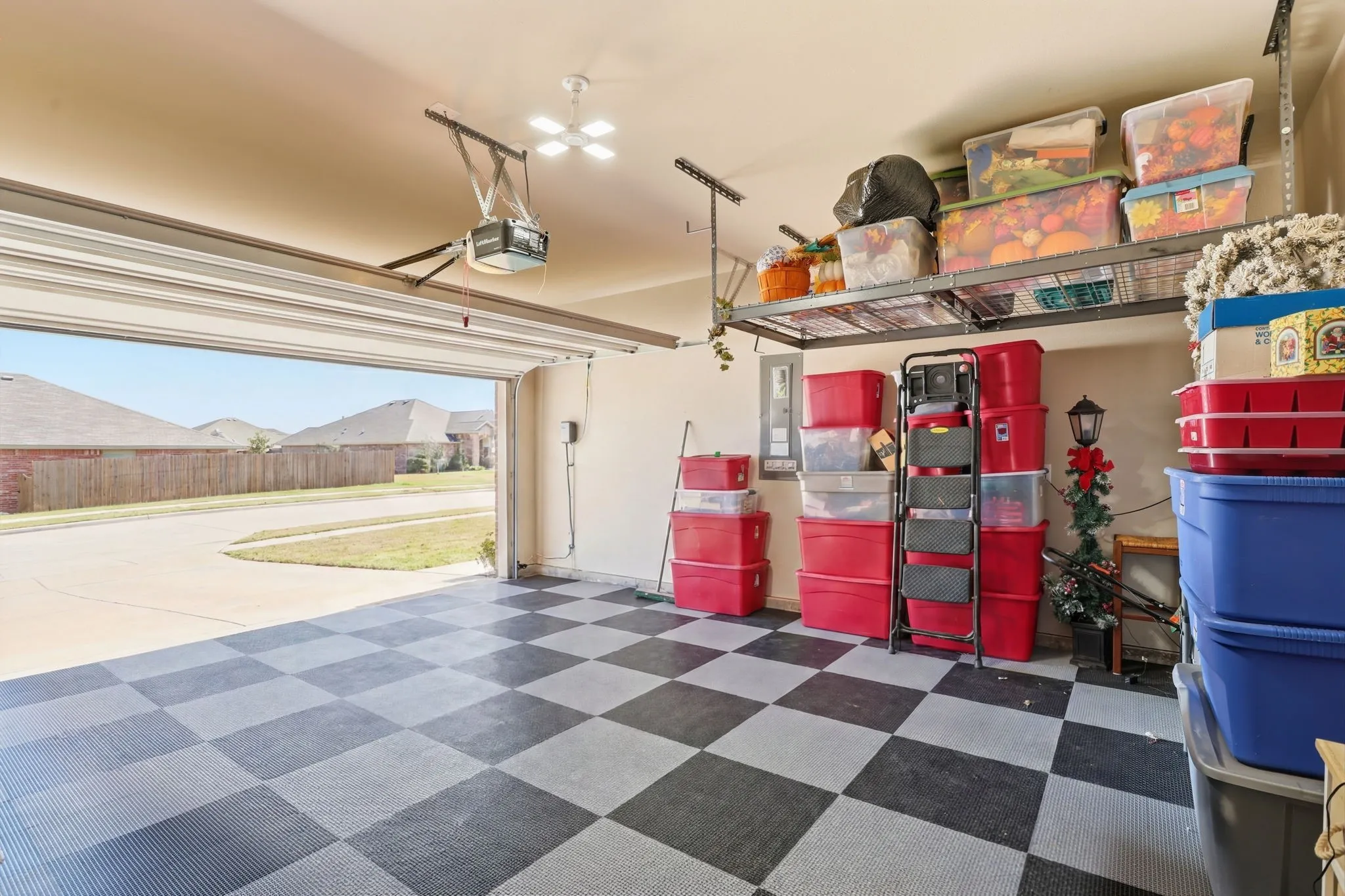 Protective flooring and overhead storage in garage.