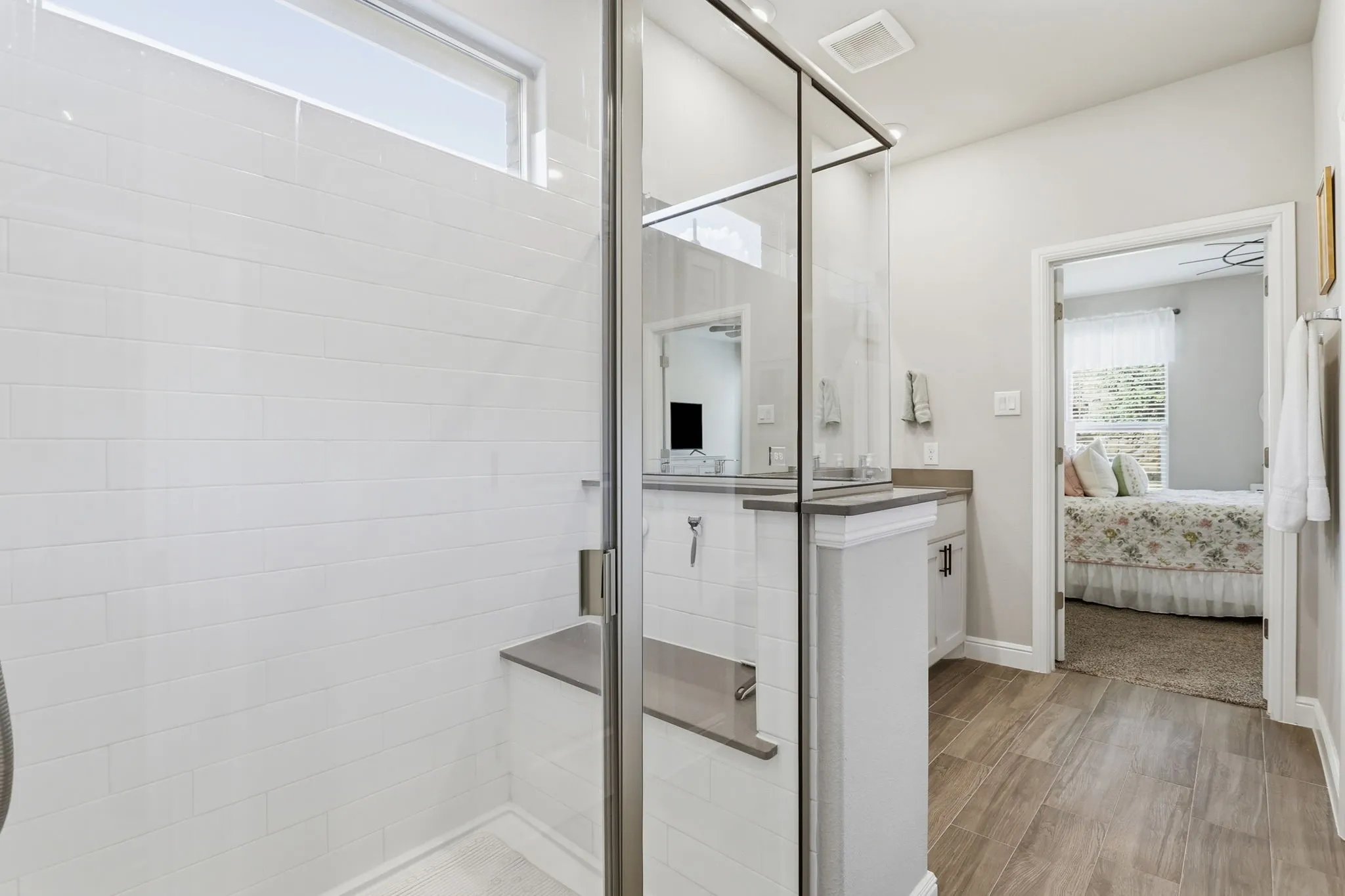 Tiled shower with seat in ensuite.