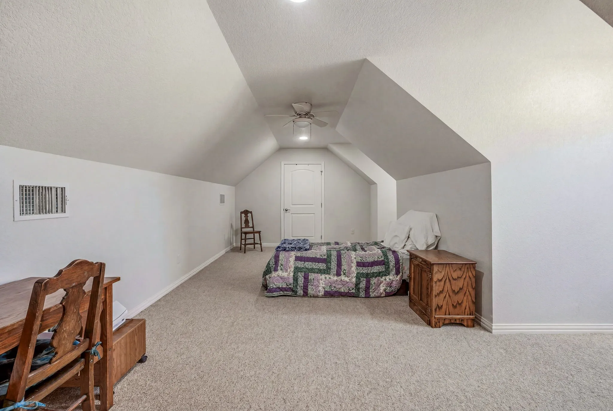 Carpeted room featuring sloped ceilings, recessed lighting, and a ceiling fan