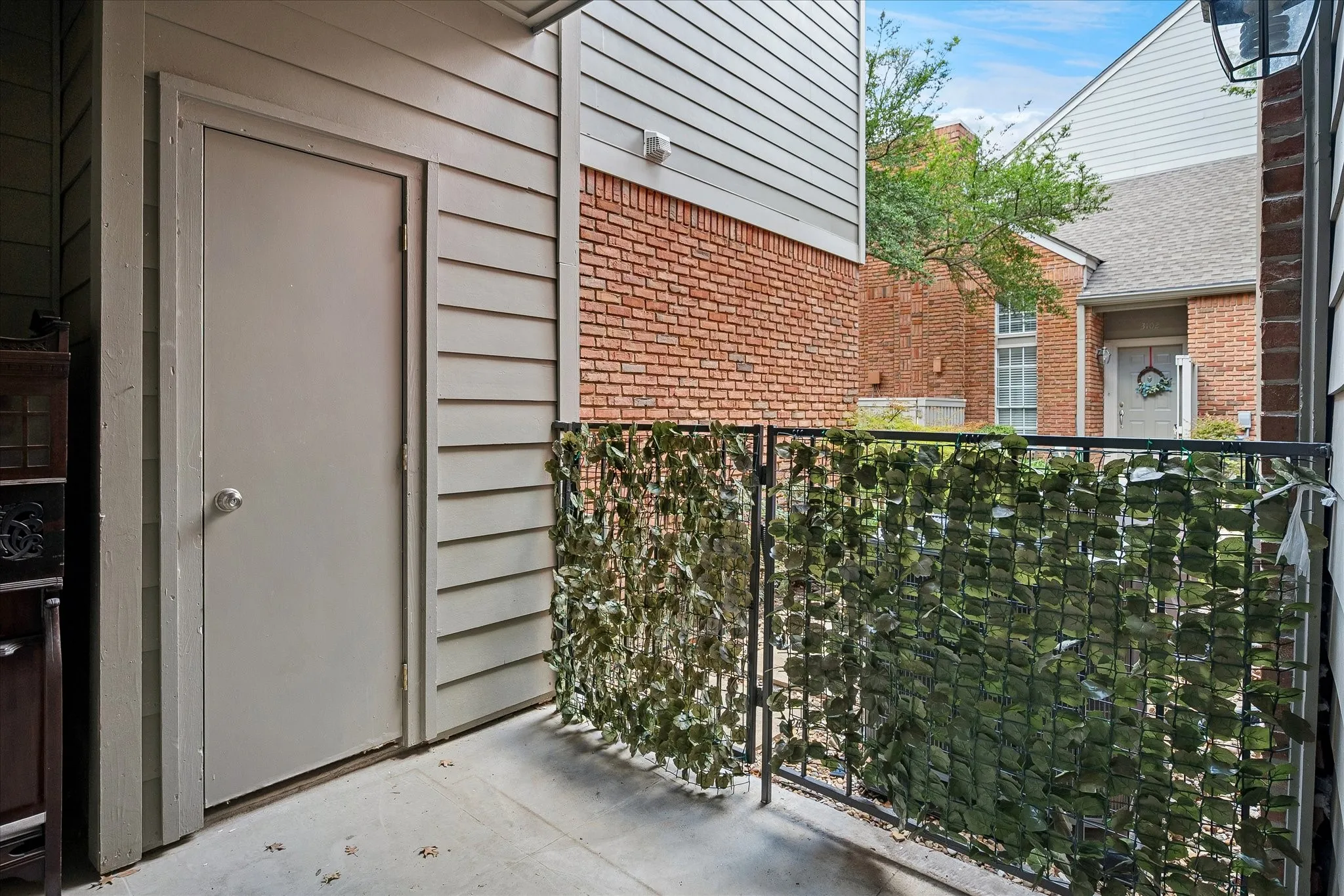 Outdoor patio with a storage closet.