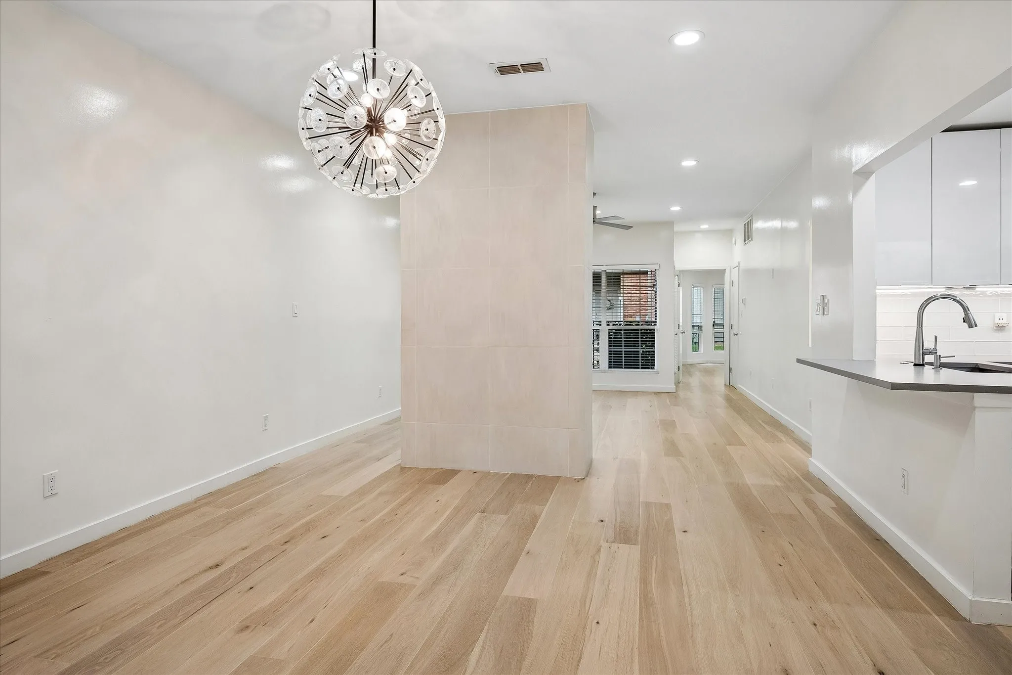 Full view of the flow between dining room and living area.  Kitchen space is conveniently located next to the dining area.