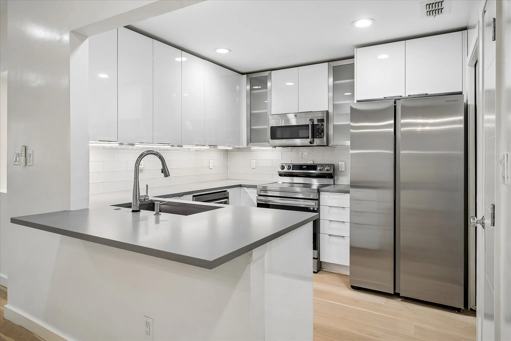 Completely updated kitchen with Kitchen Kraft acrylic cabinets.  Refrigerator conveys with the property.