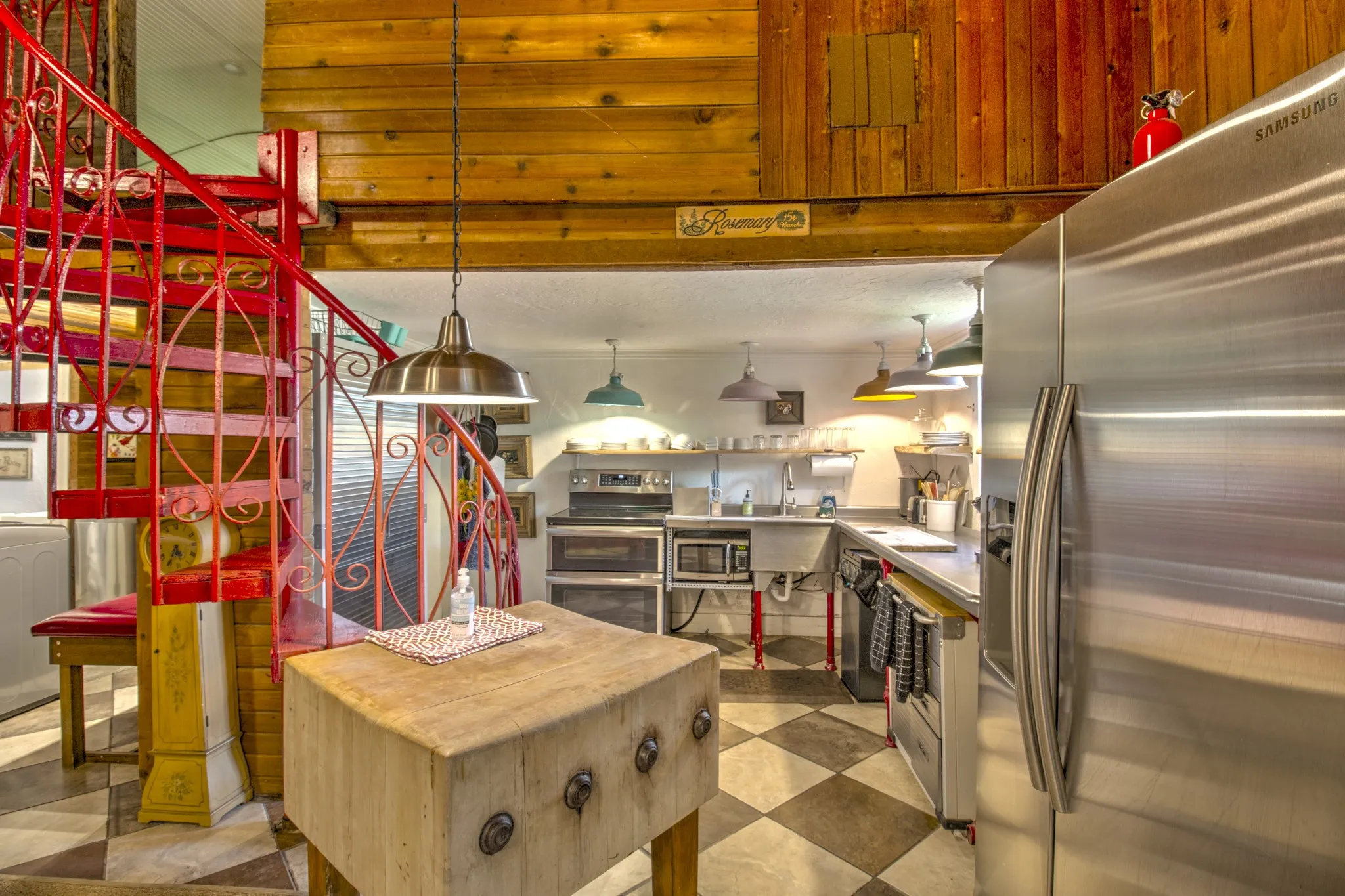 View of kitchen and spiral staircase leading to the Loft.