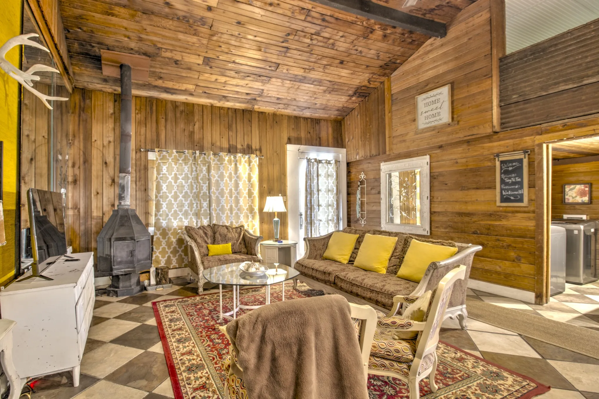 Living room features a free standing wood burning fireplace.
