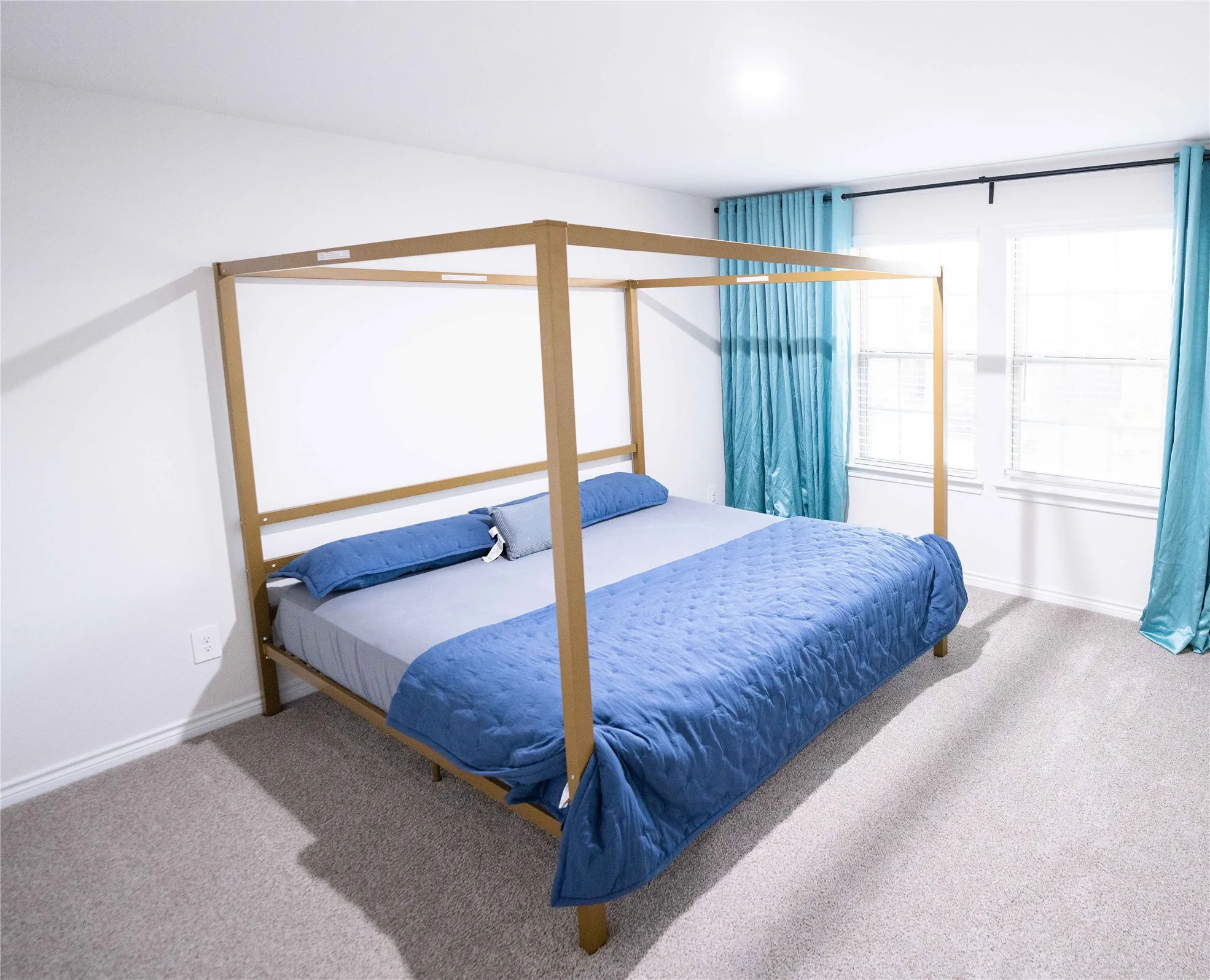 Spacious room featuring neutral carpet flooring and white walls