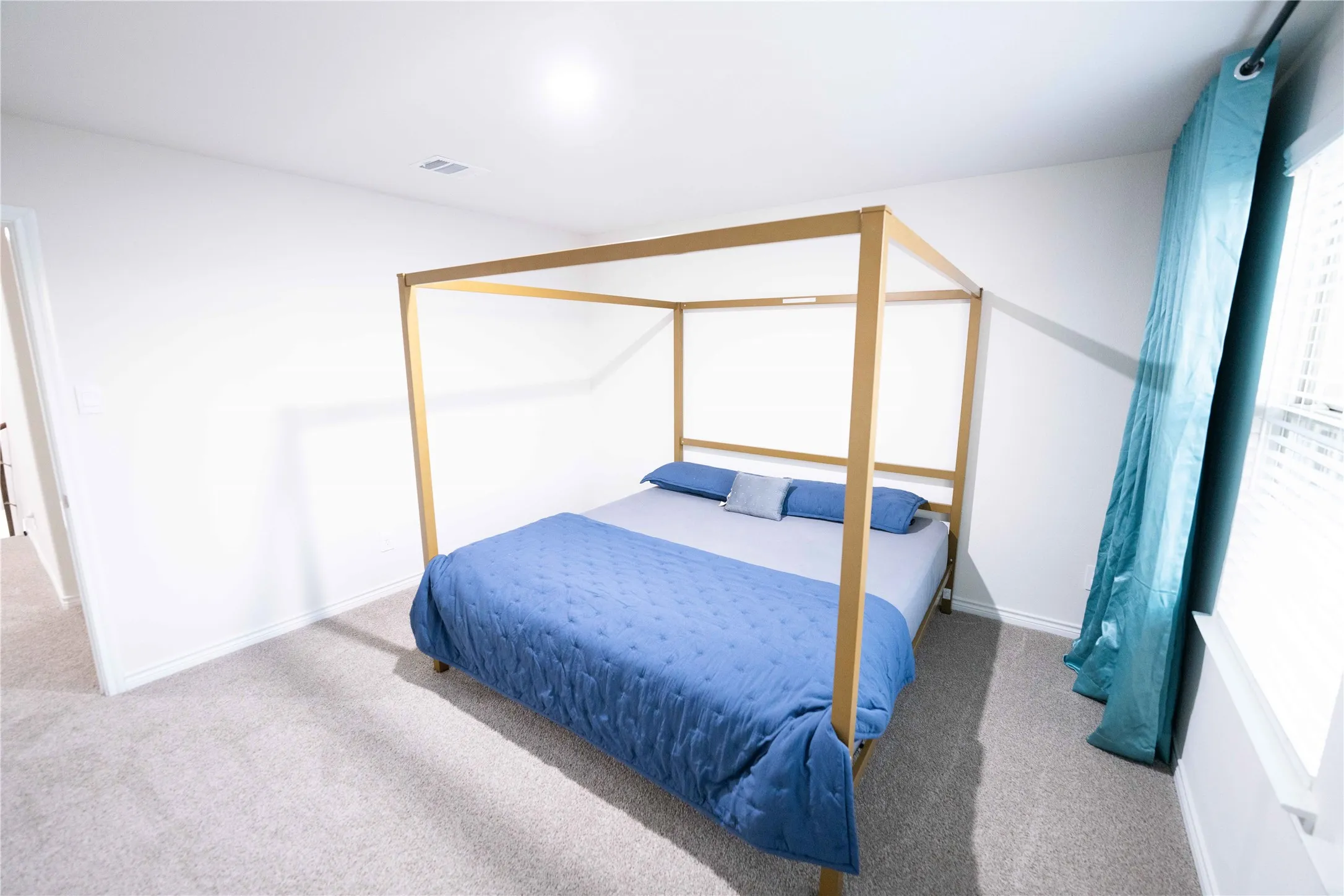 Carpeted room with white walls, a recessed ceiling light, and a window with blinds
