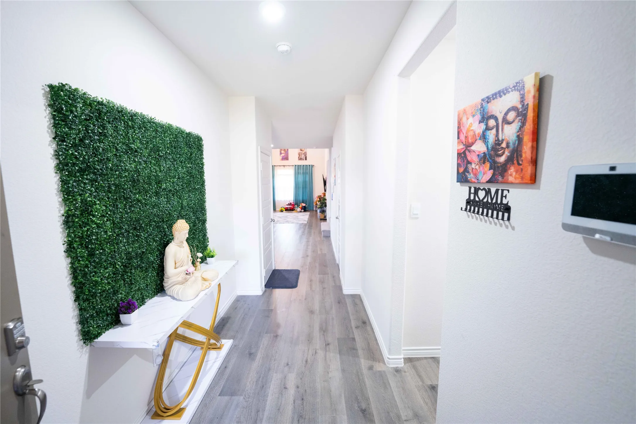 Hallway featuring wood-finish flooring, white baseboards, and recessed lighting
