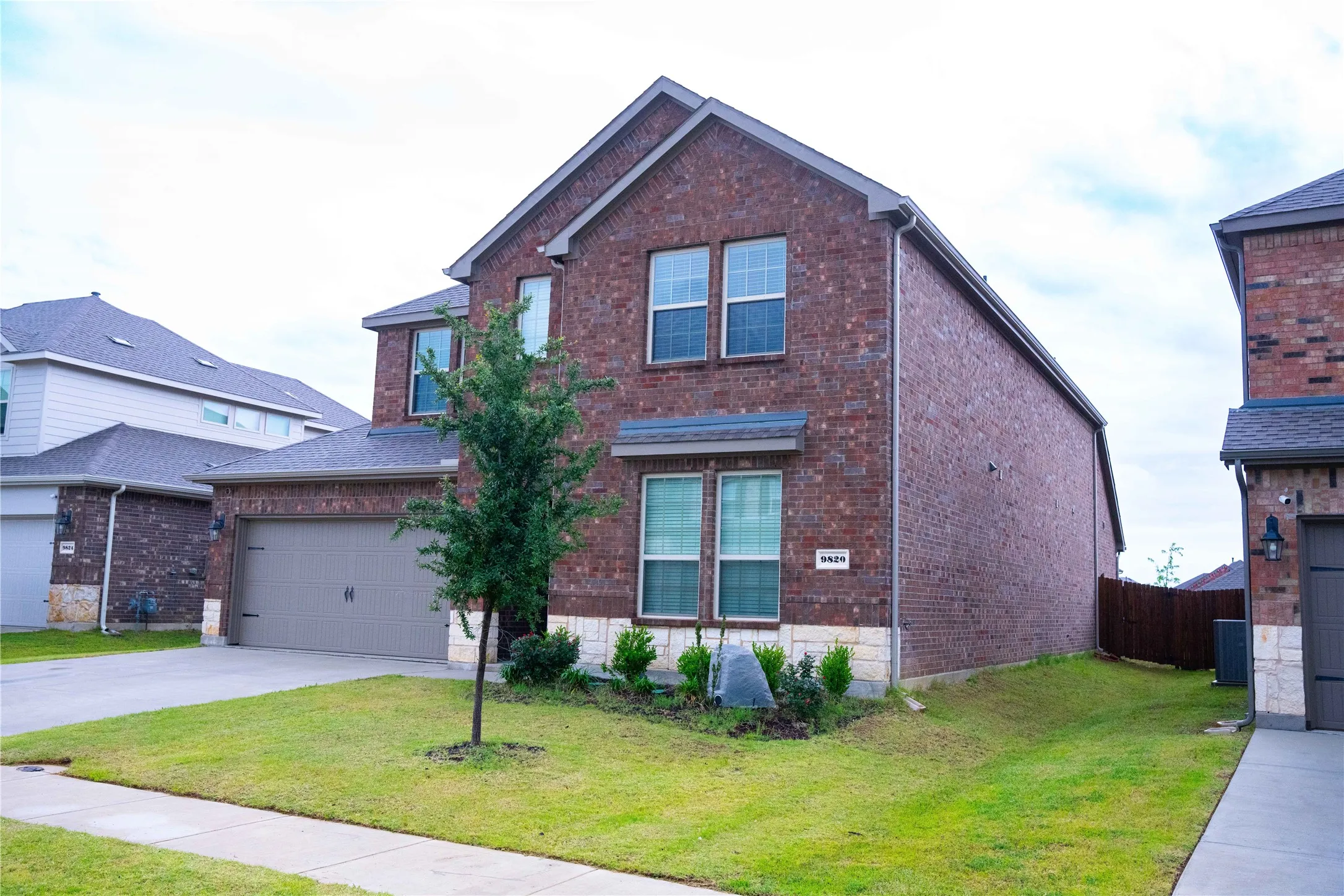 Two-story brick exterior with a stone veneer accent