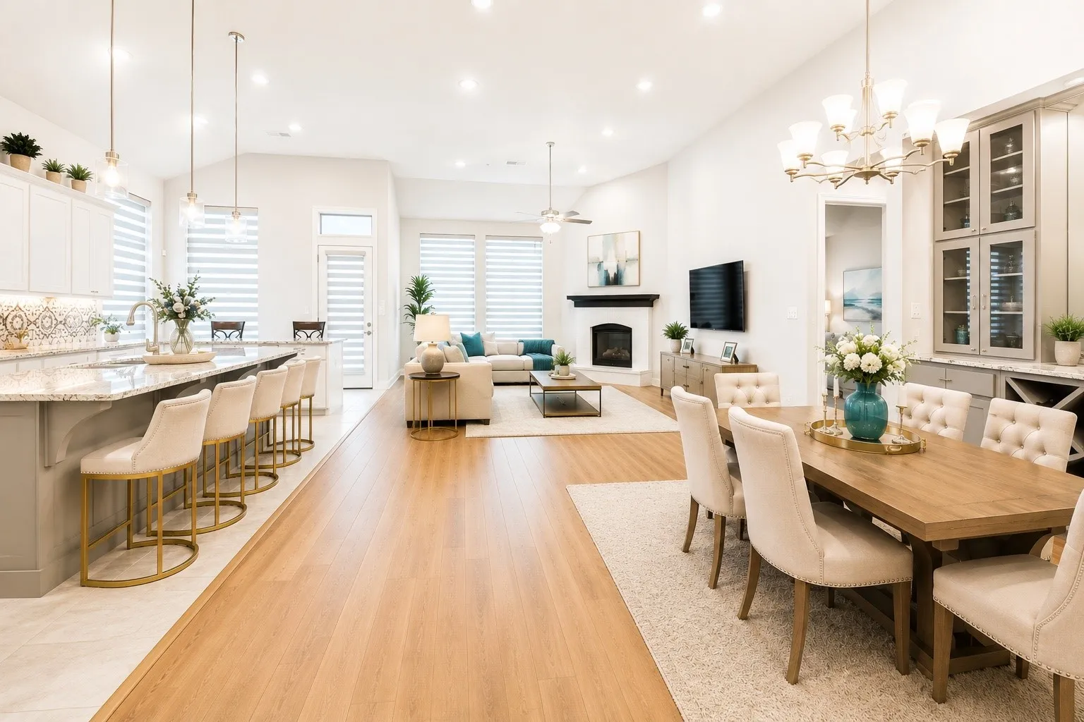 Open-concept living space featuring wood-finish flooring, a kitchen island with seating, a dedicated dining area, a fireplace, and built-in cabinetry