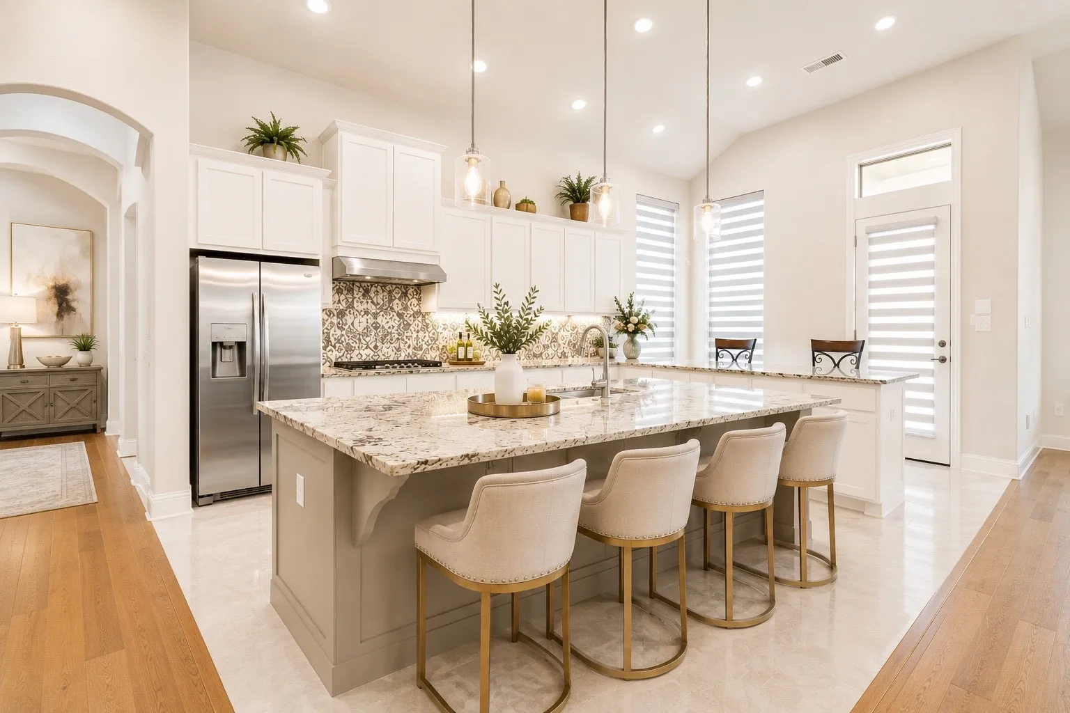 Spacious kitchen featuring an expansive island with stone countertops, a stainless steel refrigerator, patterned tile backsplash, recessed lighting, and multiple pendant lights